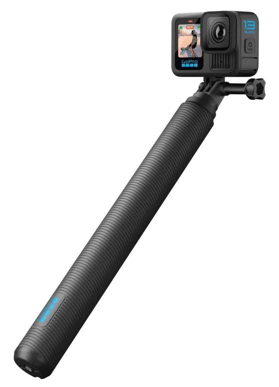 Czarna kamera GoPro przymocowana do czarnego kija do selfie. Kamera wyświetla osobę jeżdżącą na nartach. Tło jest białe.