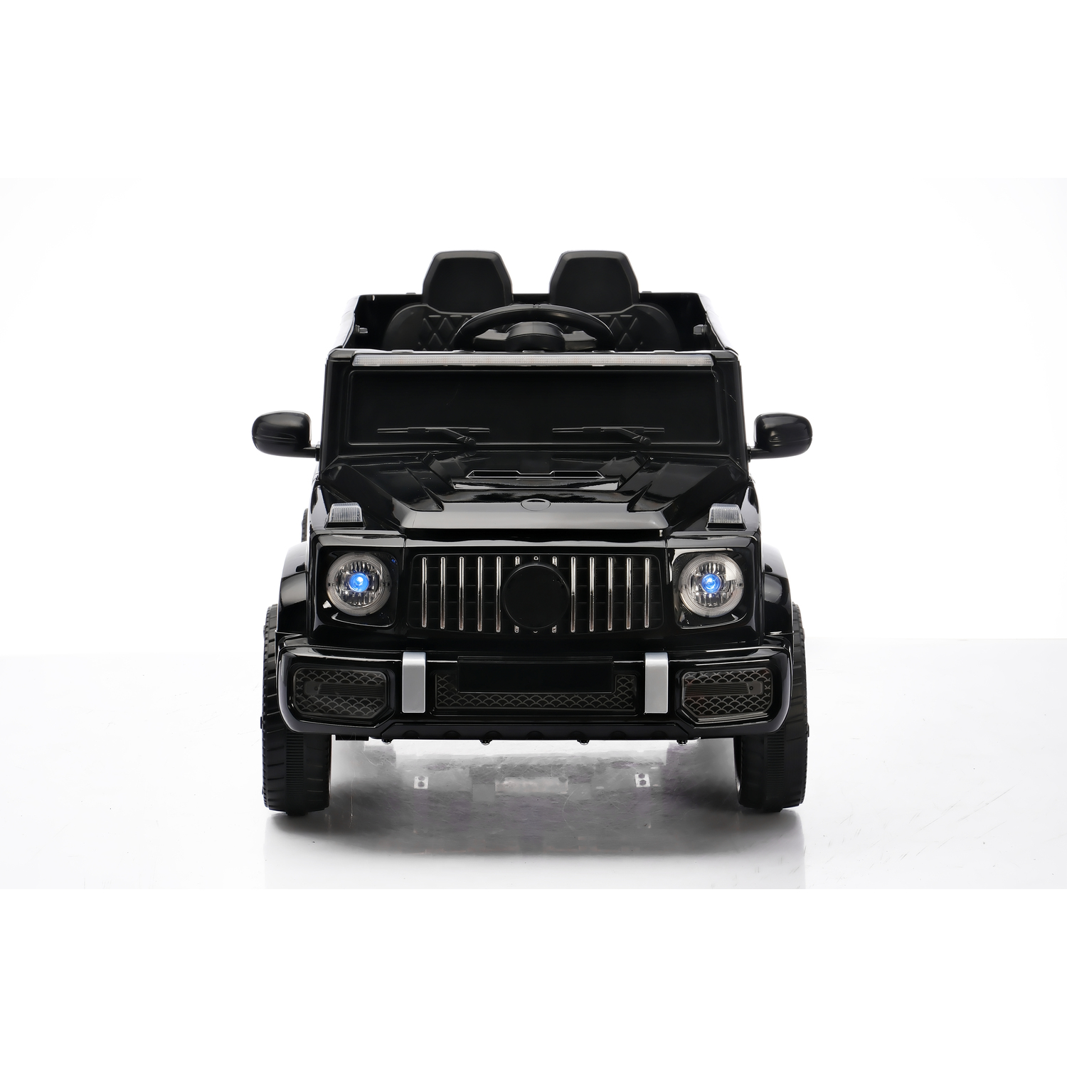 A black toy car, a miniature SUV, is centered. It has blue headlights, a grill, and a reflective surface. The background is white.
