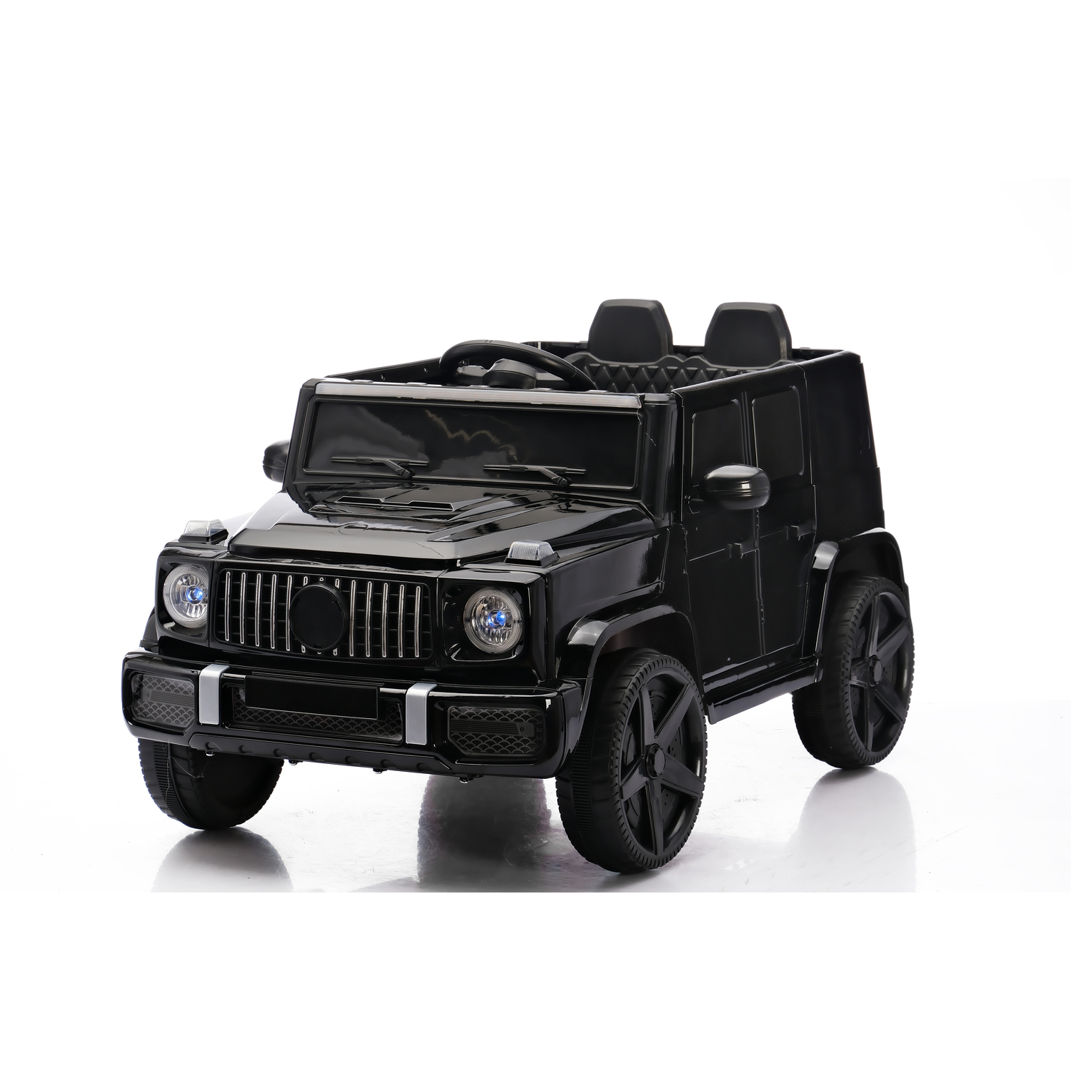 A black toy car resembling a SUV is on a white surface. It has two seats, a steering wheel, and large black wheels.