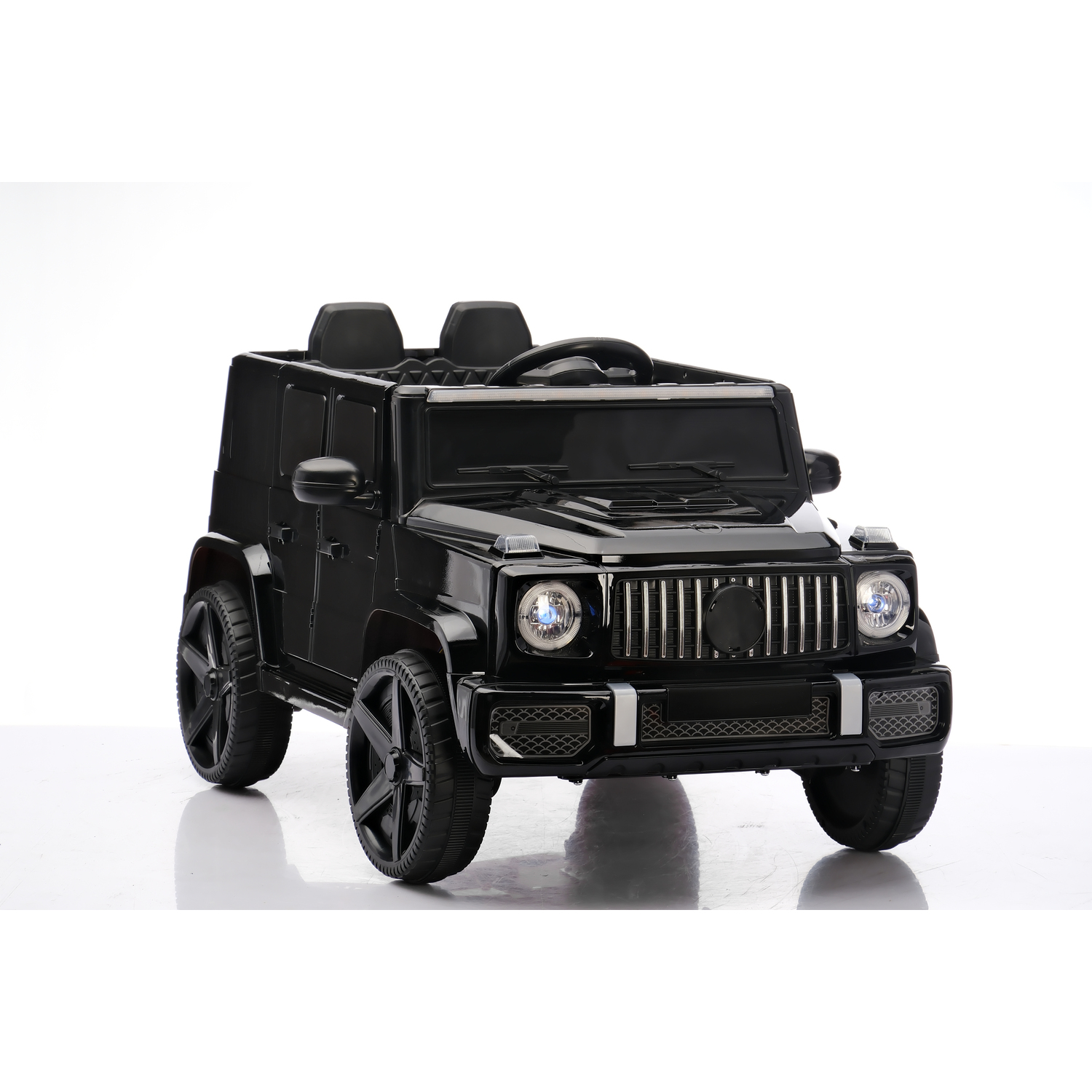 A black toy SUV is centered on a white surface. It has black wheels, a front grill, and two small seats visible.
