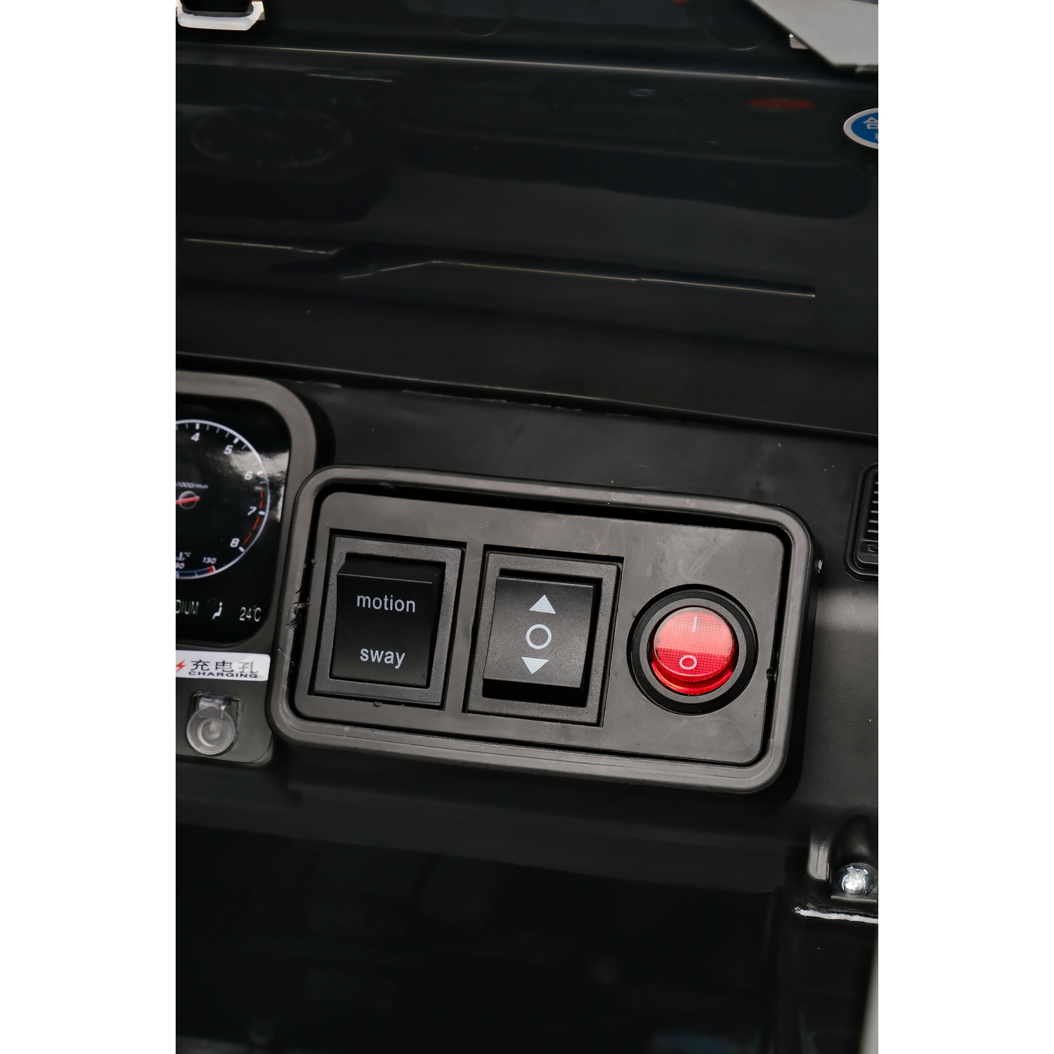 Dashboard of a black toy car with buttons for motion, sway, and a red power button. Gauges are visible on the left.