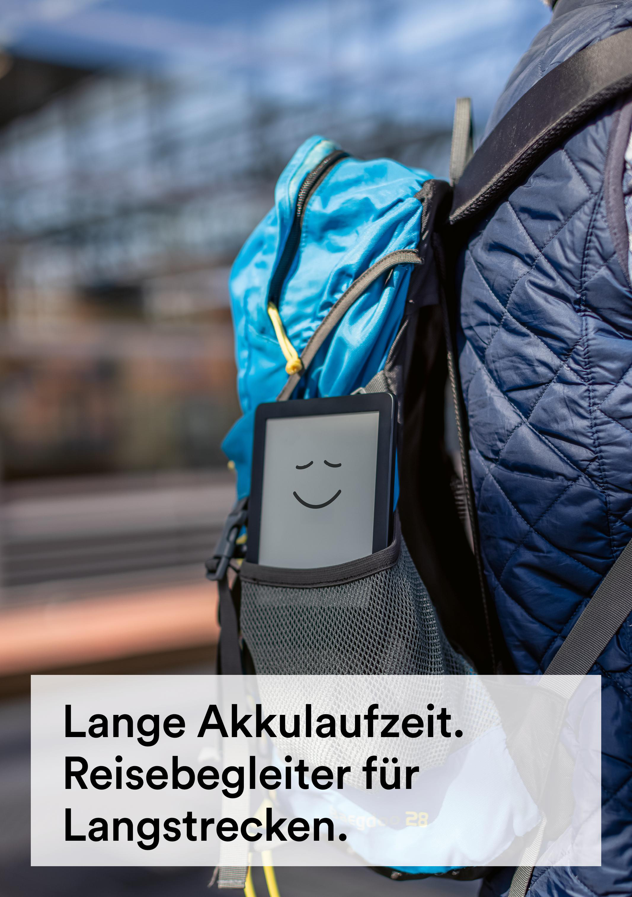 Eine Person mit Rucksack hat ein Tablet mit Smiley-Gesicht in der Seitentasche. Der Hintergrund ist unscharf.