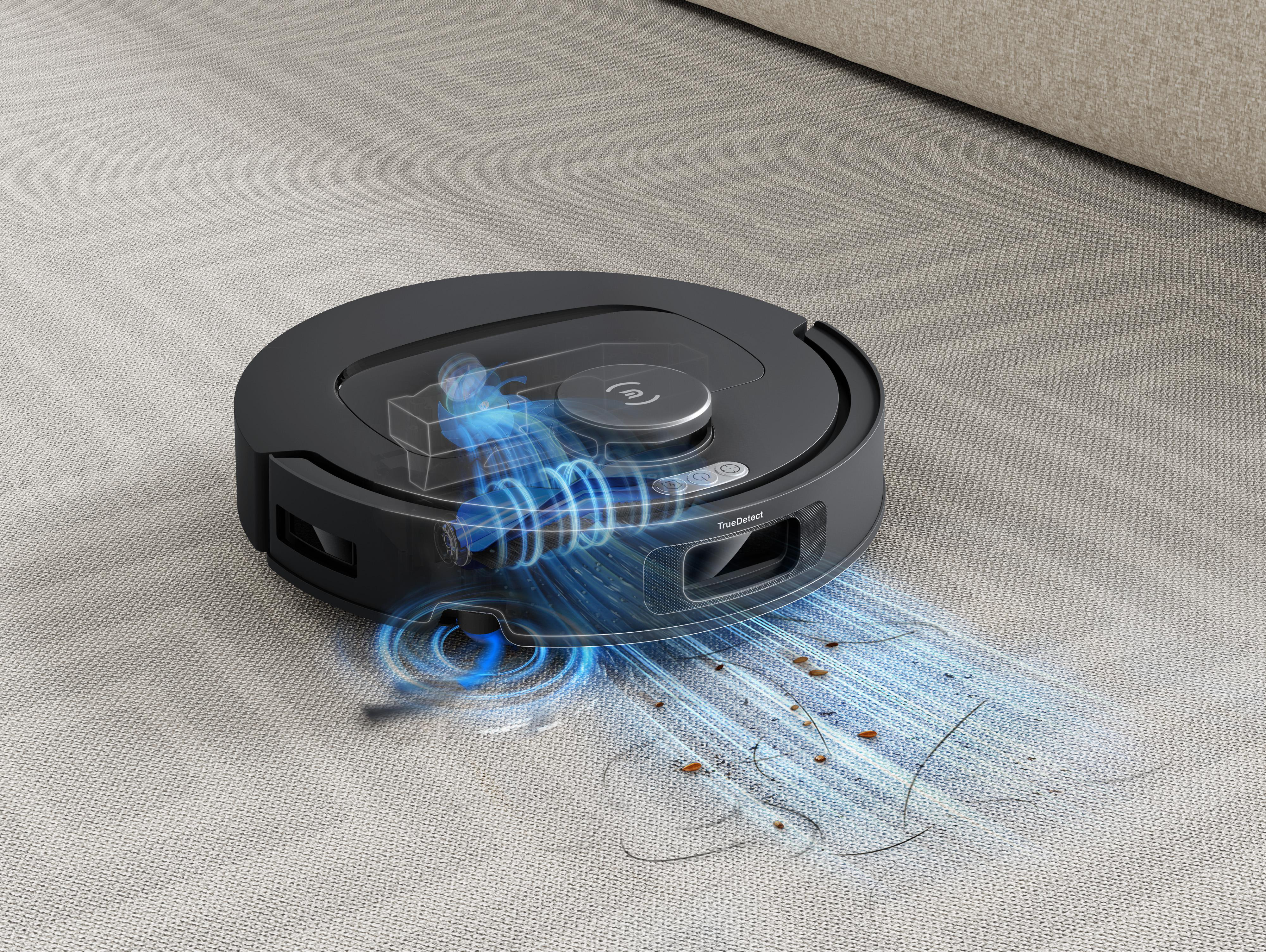 Ein schwarzer Roboter-Staubsauger, der einen Teppich reinigt. Blaue Linien zeigen die Saug- und Schmutzentfernung.