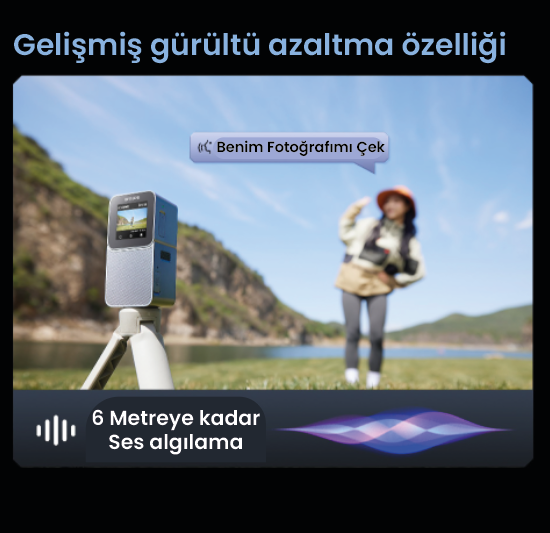Arka planda turuncu şapkalı bir kadın var. Ön planda bir tripod üzerinde bir cihaz. Sahne, bir gölle birlikte açık havada.