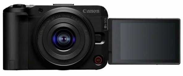 Czarny aparat Canon EOS R z obiektywem, odchylanym ekranem i czerwonym przyciskiem. Obiektyw ma napisy. Ekran jest ciemny.