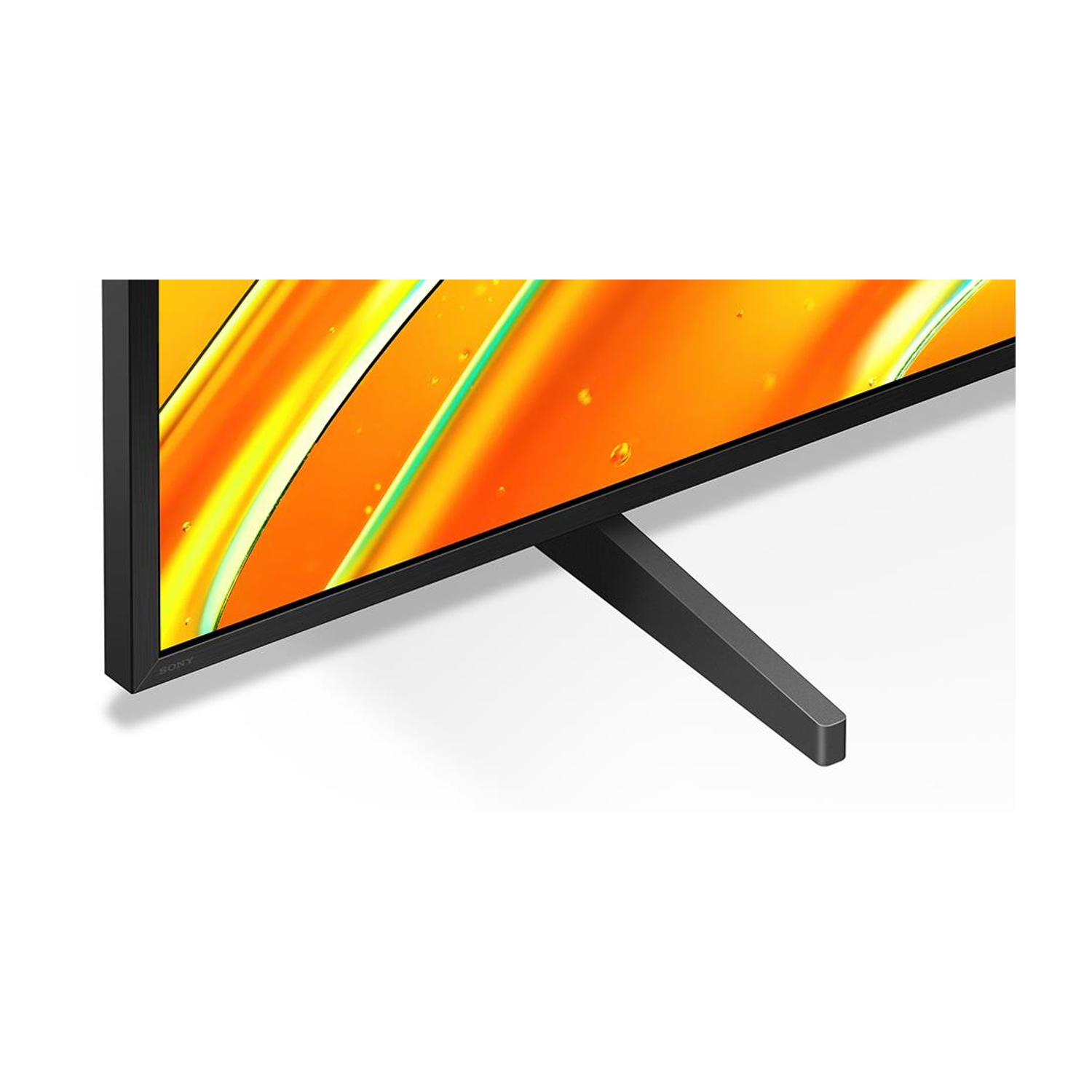 Un televisore Sony nero è mostrato con lo schermo che mostra colori gialli e arancioni. Il televisore ha un supporto nero.