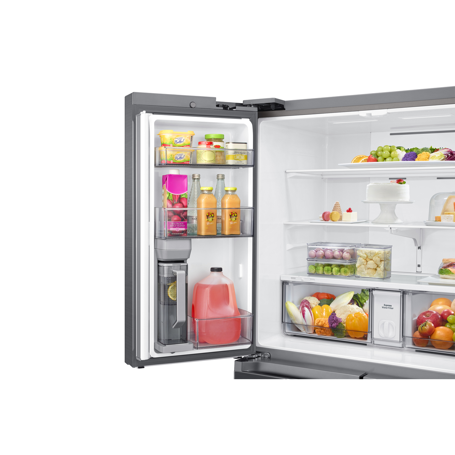 An open refrigerator filled with food. Shelves display butter, juice, fruits, vegetables, and a cake. A water dispenser is visible.
