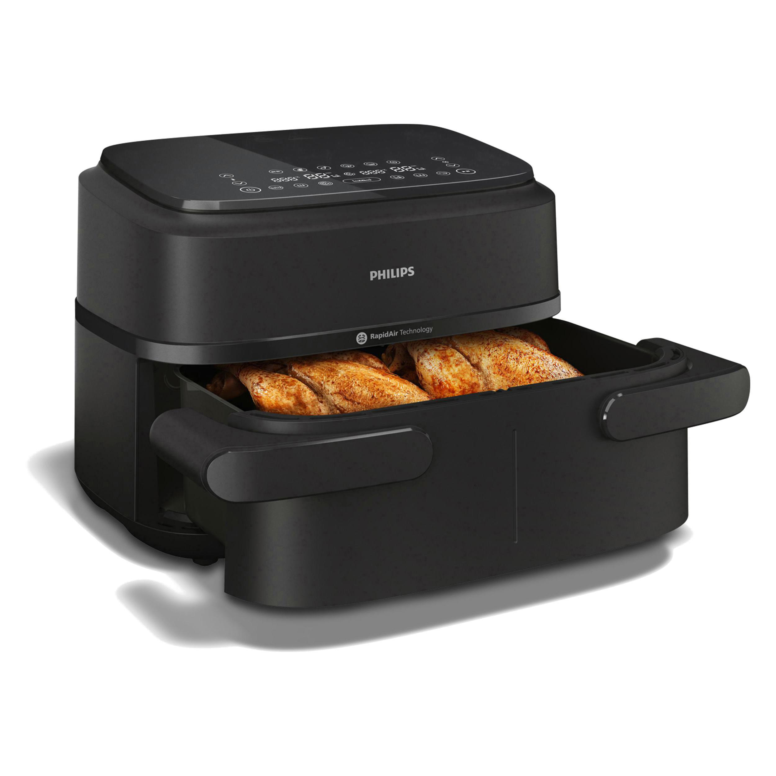 Schwarze Philips Heißluftfritteuse mit Hähnchen innen. Bedienelemente oben. RapidAir-Technologie sichtbar.