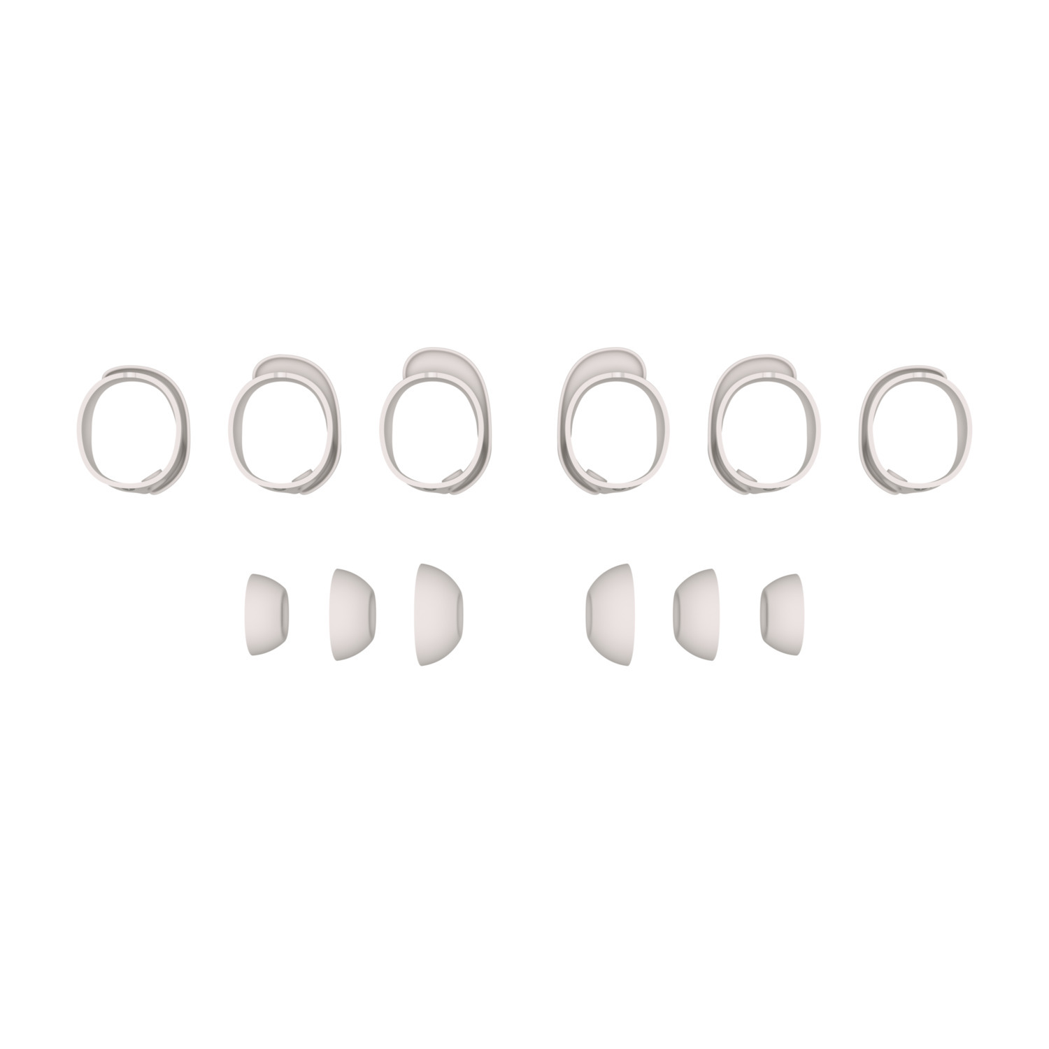 Six earbud rings and three pairs of ear tips are arranged on a white surface, likely a product shot.