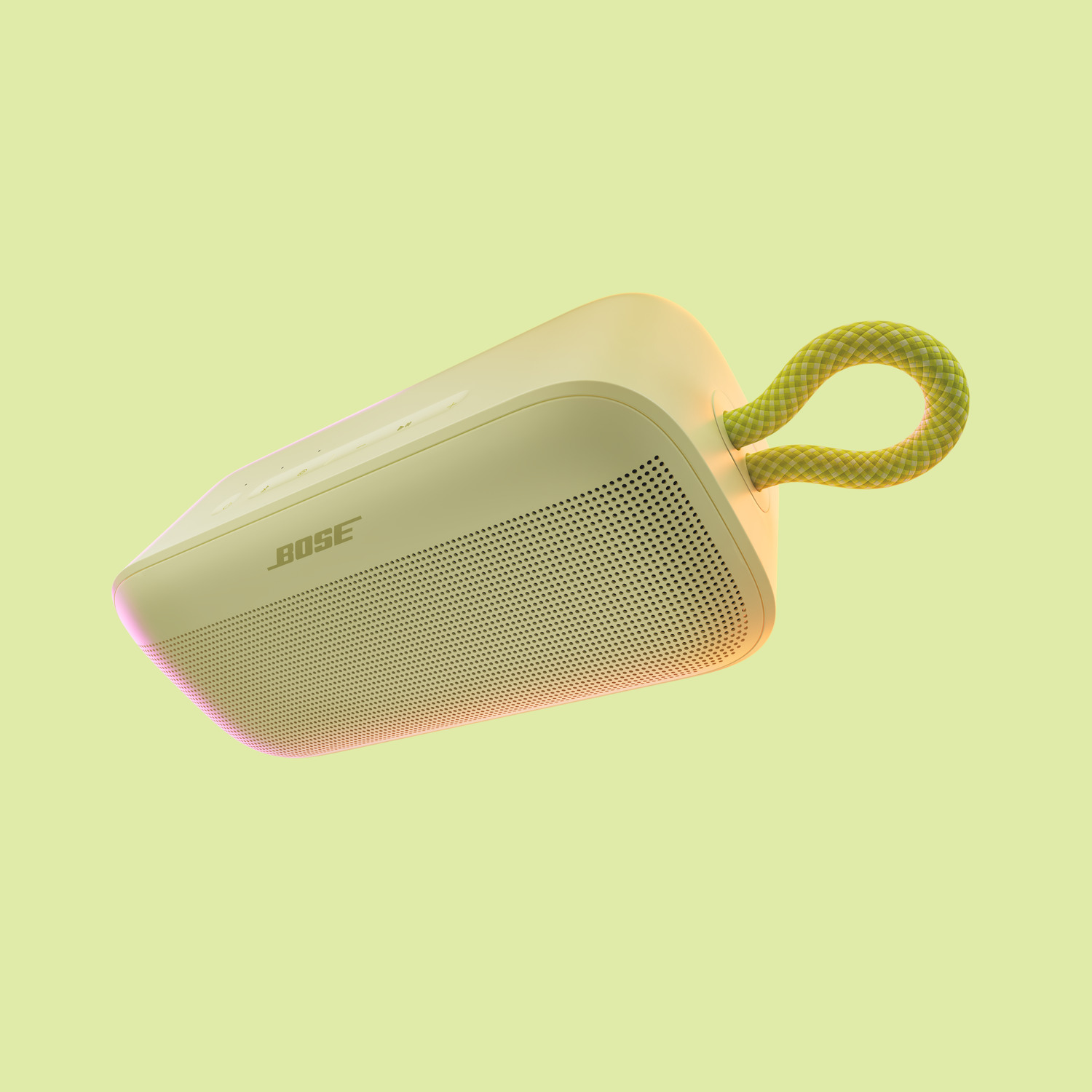 Een lichtgele Bose-luidspreker met een geelgroen touwhandvat, op een lichtgele achtergrond.