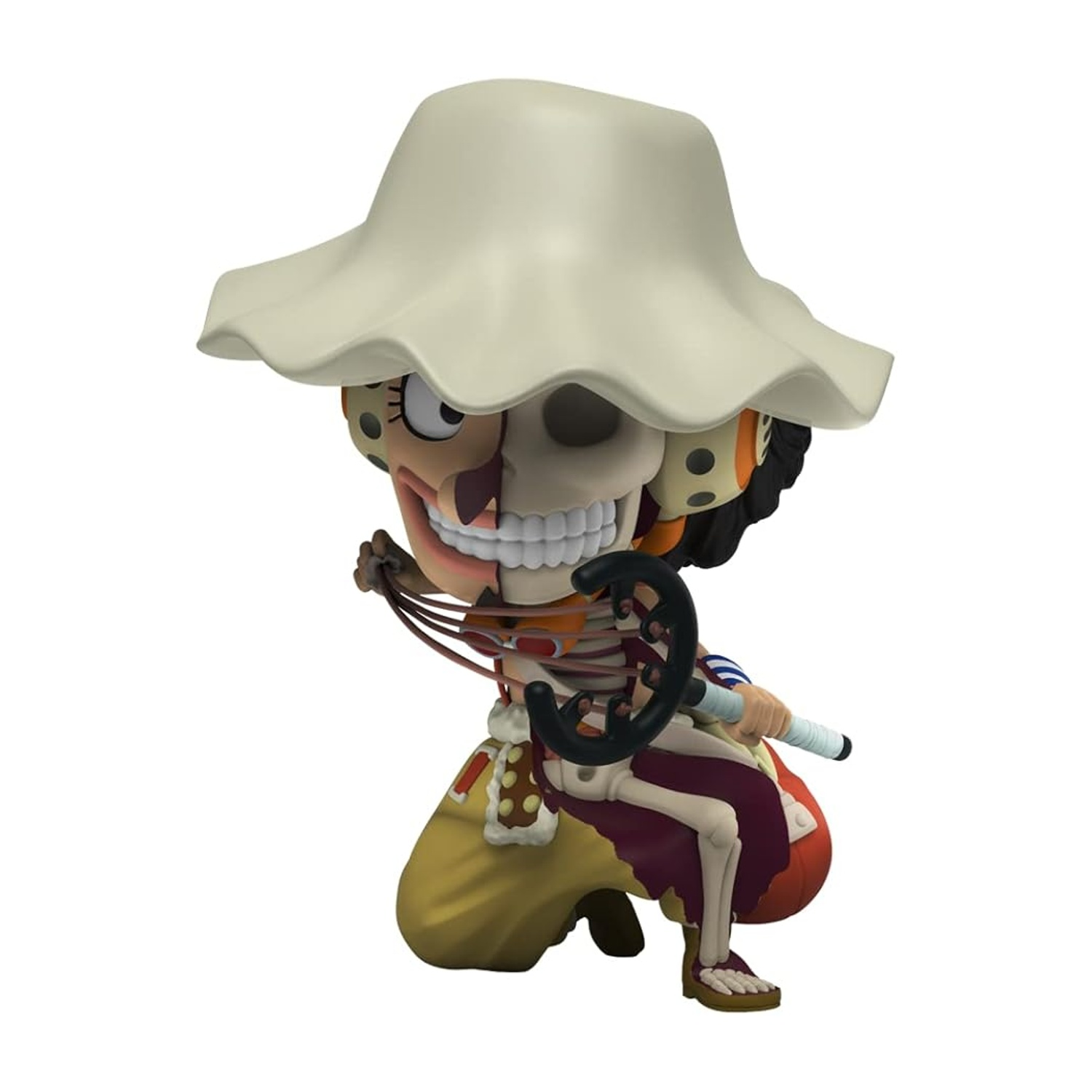 Una statuetta, metà scheletro, metà carne, con un cappello, che tiene un'arma, su sfondo bianco.