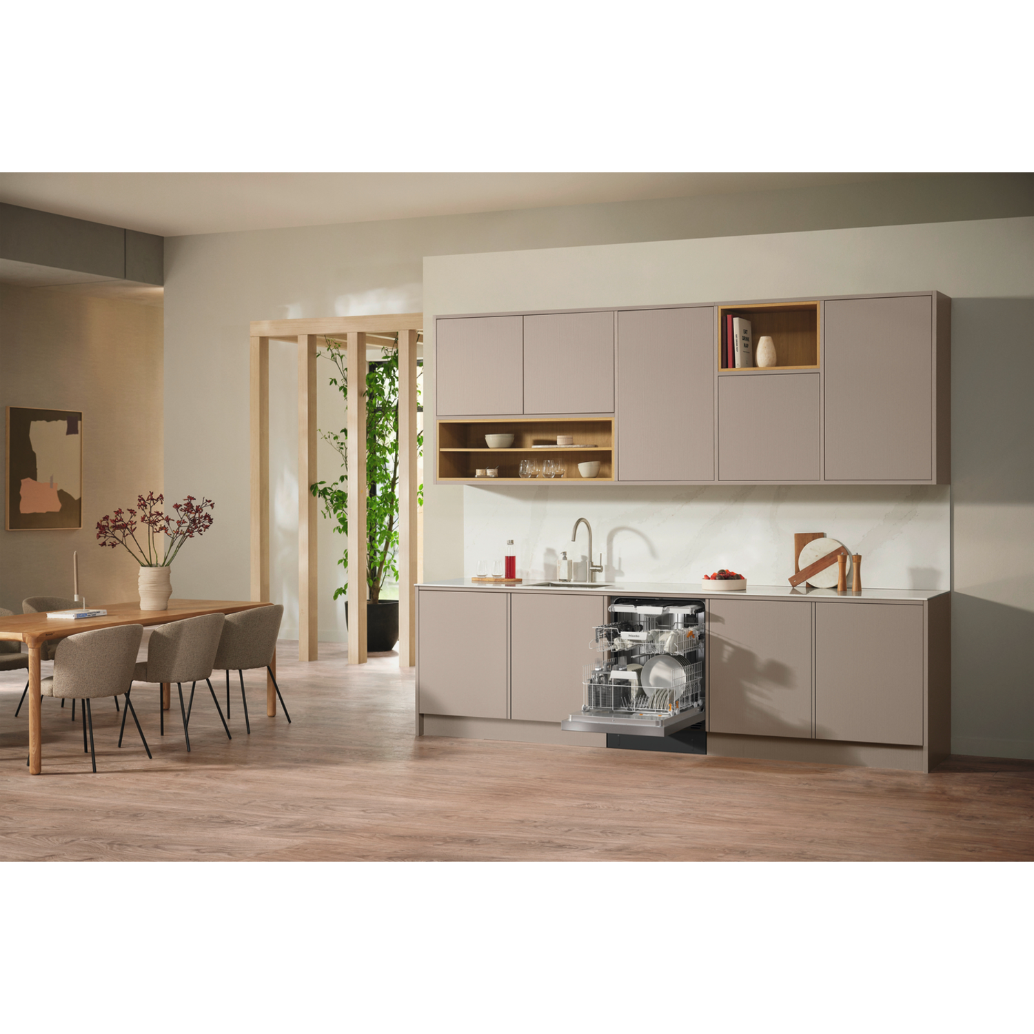 A modern kitchen with open dishwasher. A dining table with chairs is on the left. Cabinets and a wooden floor are present.