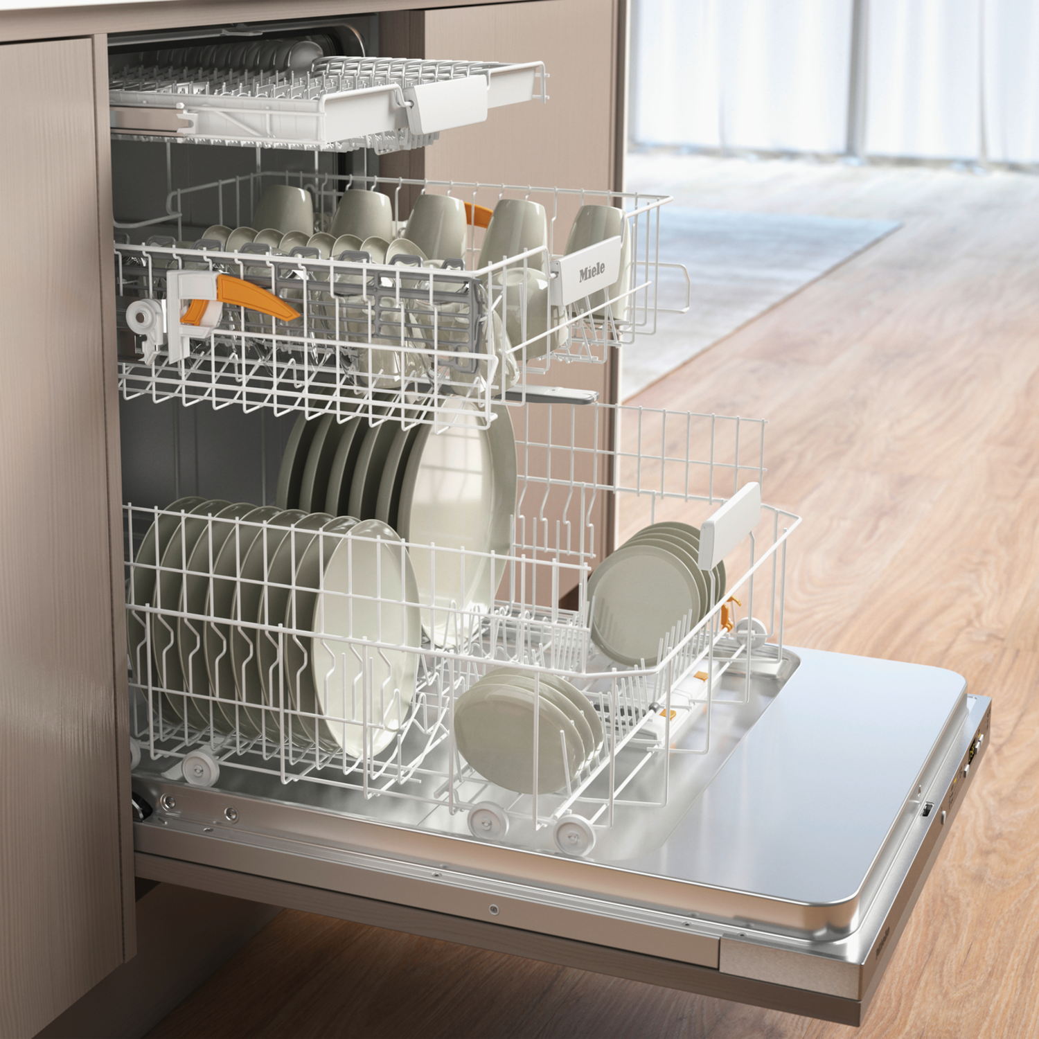 Open dishwasher with plates and cups inside. Dishwasher is in a kitchen with wooden floor.