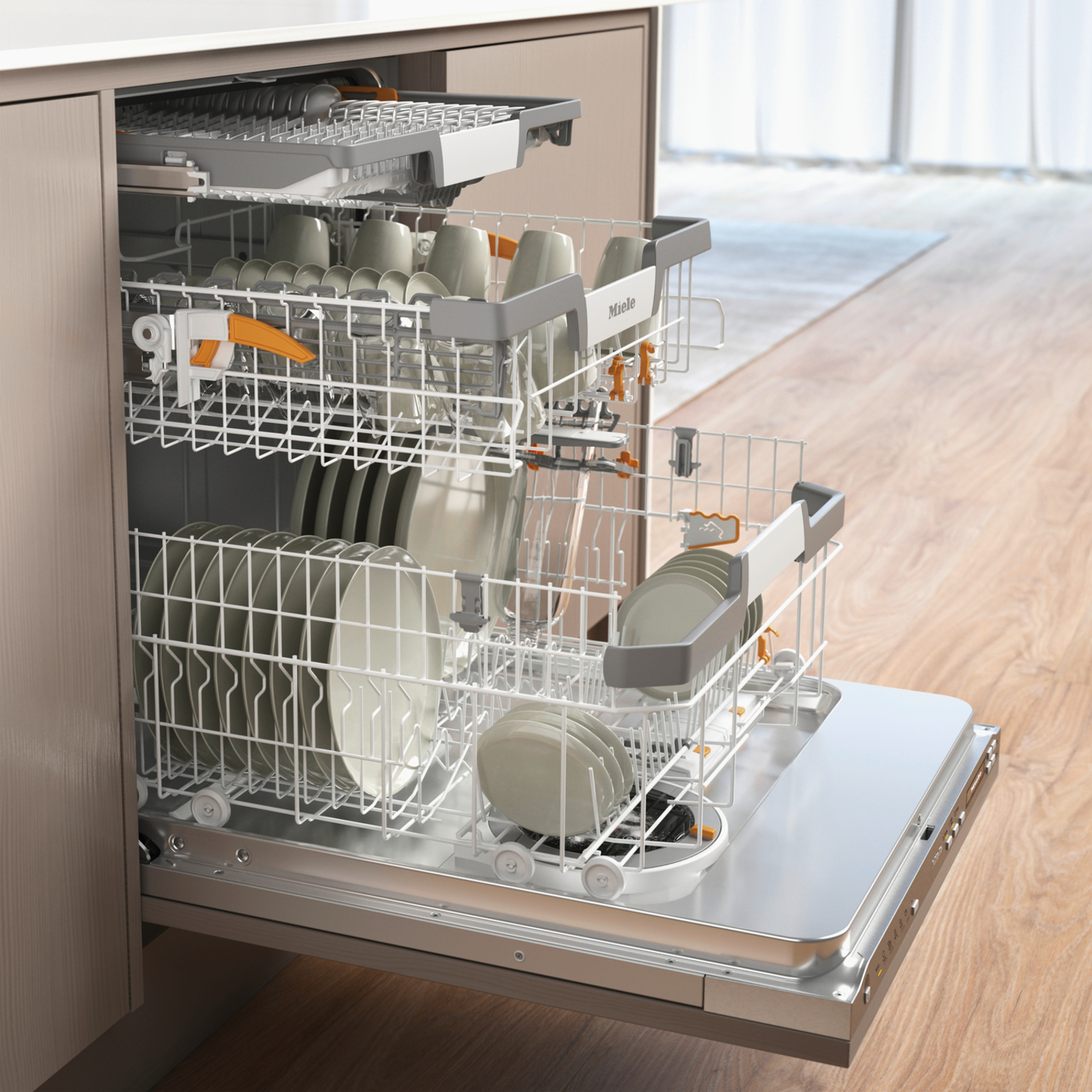Open dishwasher with plates, cups inside. Wooden floor and beige cabinets in the background. Miele brand.