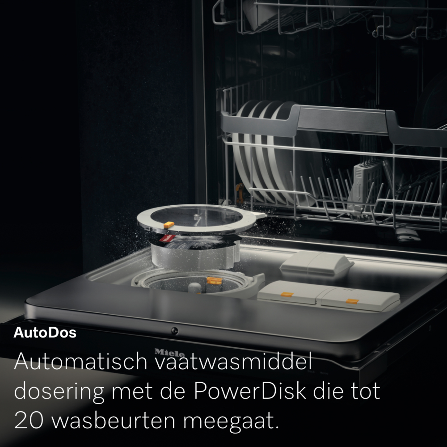 Dishwasher interior showing AutoDos system and PowerDisk. Plates and utensils are visible in the racks. Text reads: Automatic detergent dosing.
