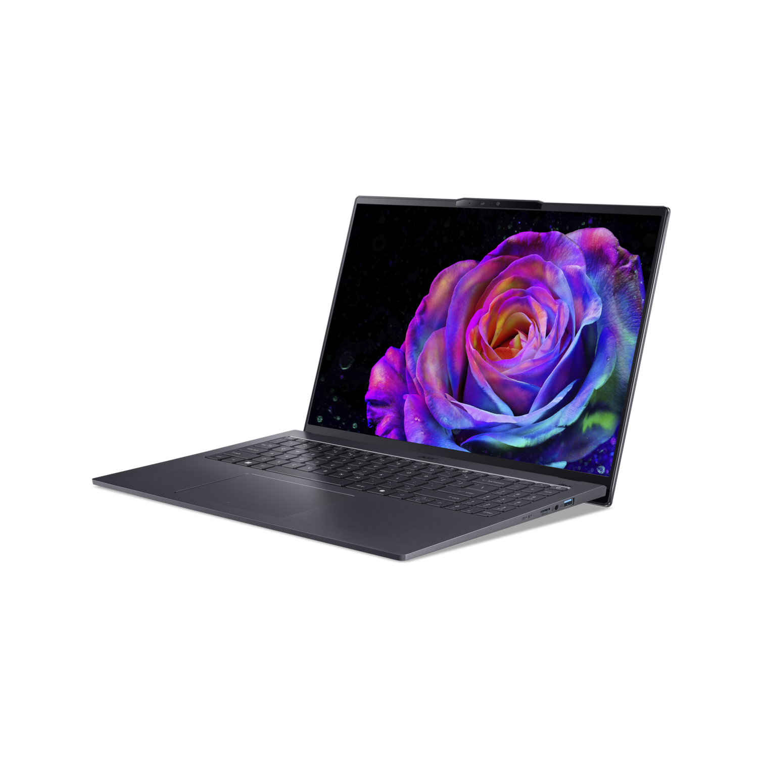 A laptop displays a colorful rose against a black background. The laptop is dark gray, slightly open, and set against black.