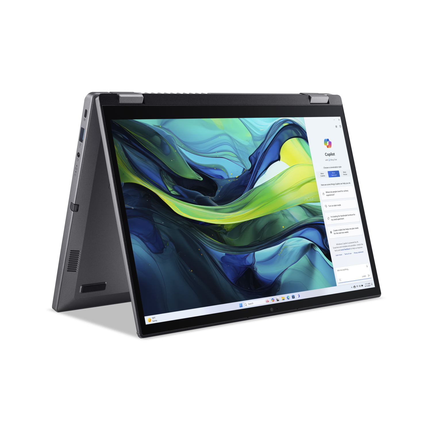 Een zilveren laptop is open, met een kleurrijke abstracte afbeelding. Het scherm toont een Copilot-interface, met een zwarte achtergrond.