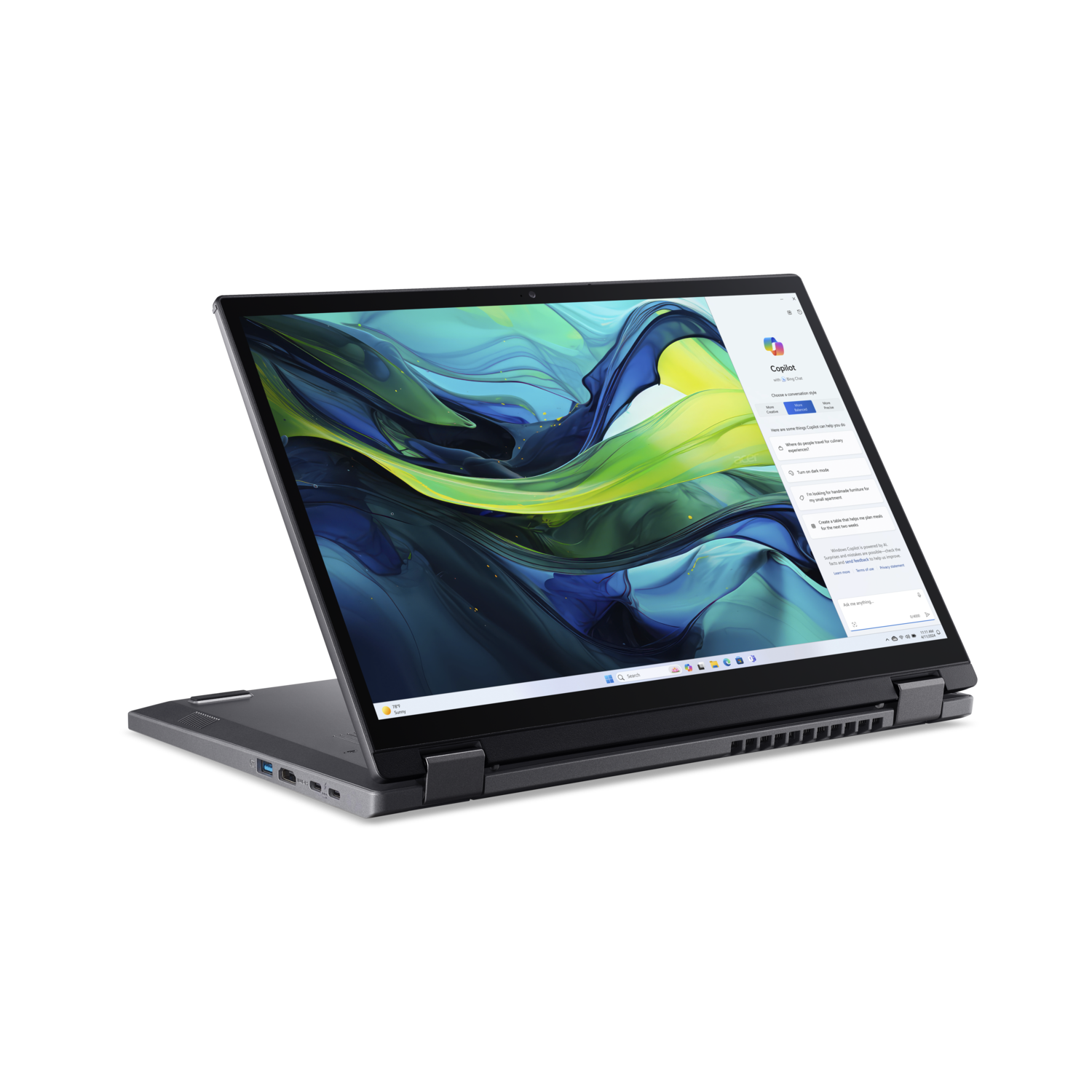 Laptop open, showing Copilot. Black frame, screen has blue/green abstract art.