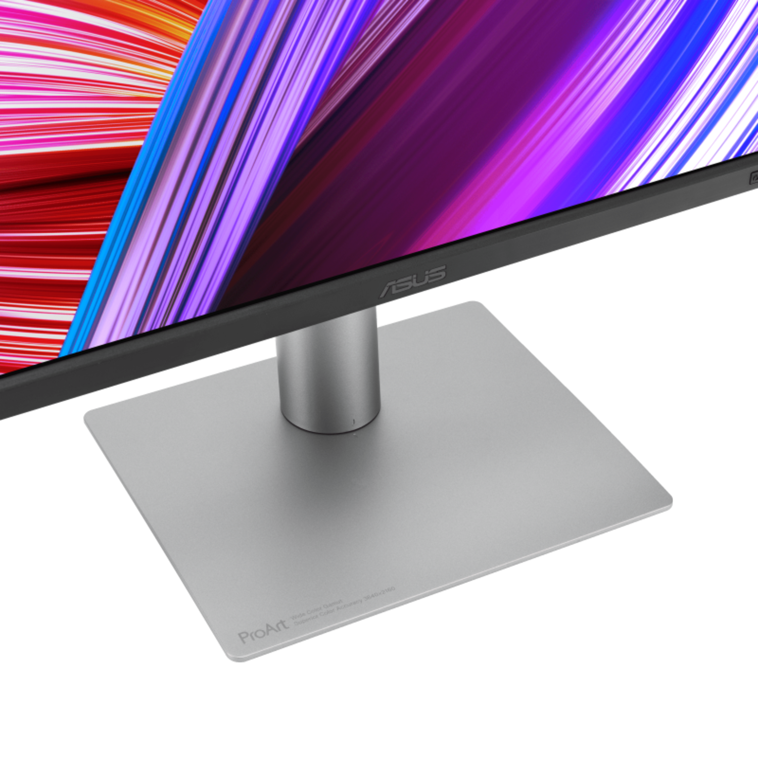 A silver computer monitor with a black frame, displaying colorful abstract art. The monitor has a silver stand, and the brand name is ASUS.