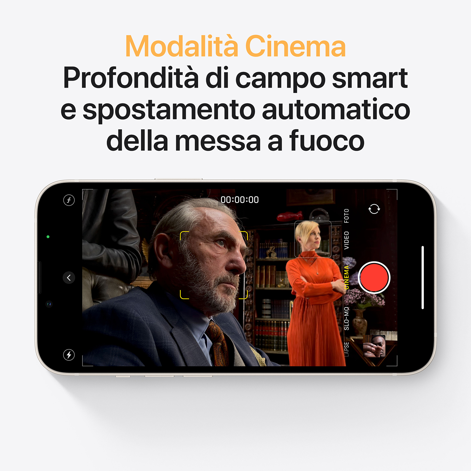 Schermo iPhone che mostra la modalità cinema. Uomo in giacca e donna in abito rosso a fuoco. Testo in alto: modalità cinema e messa a fuoco.