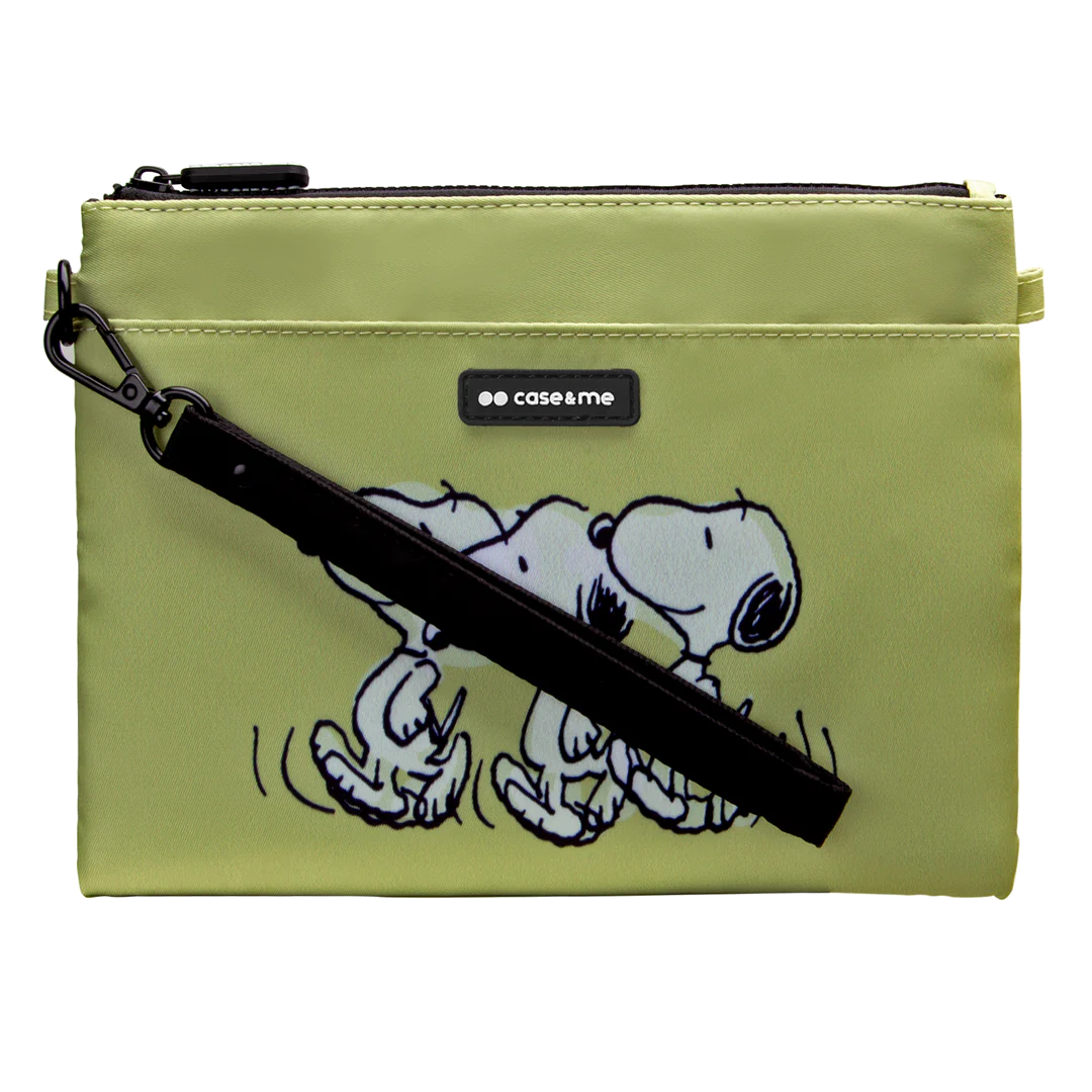 Zielona kosmetyczka z postaciami z kreskówek Snoopy'ego. Ma czarny pasek i logo 'case&me'. Tło jest czarne.