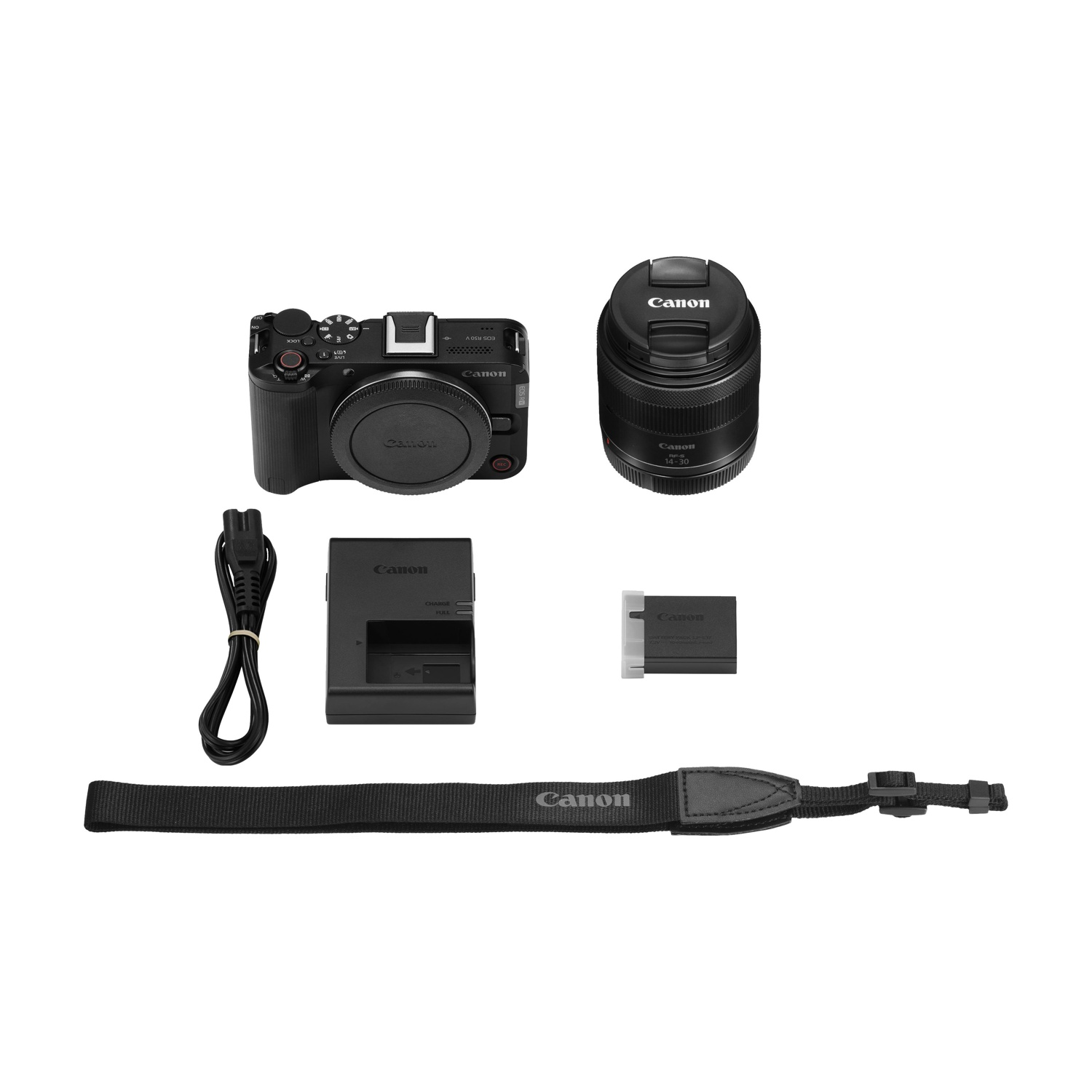 Un kit fotocamera Canon include corpo macchina, obiettivo, caricabatterie, batteria, cinturino e cavo di alimentazione, tutto su sfondo bianco.