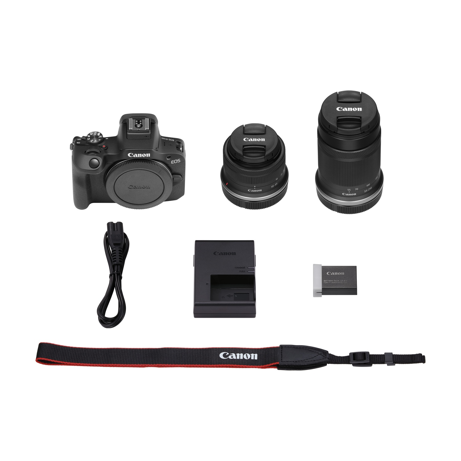 Un kit fotocamera Canon nero è disposto su una superficie bianca. Include corpo macchina, obiettivi, caricatore, batteria e cinturino.