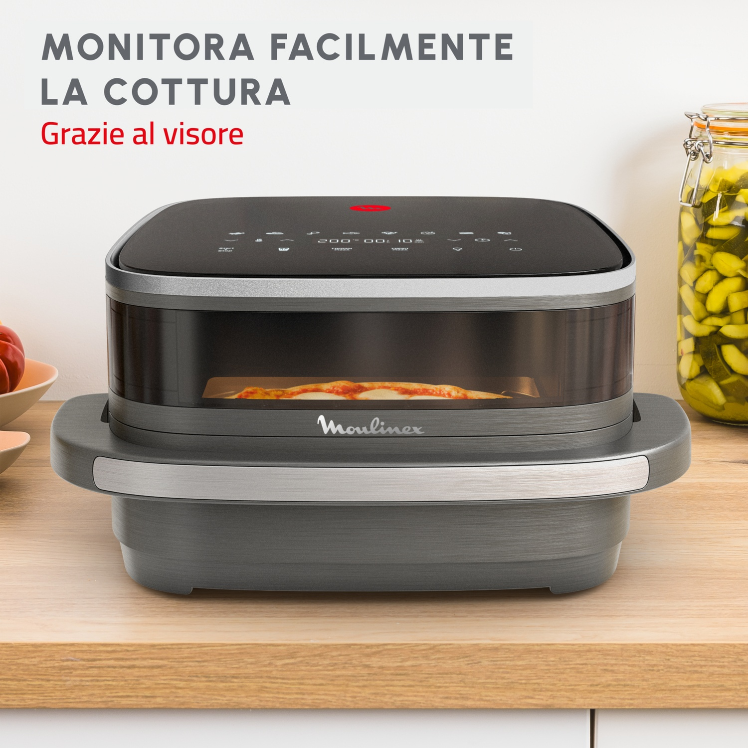 Un forno nero e grigio con pizza dentro. Il testo sopra dice 'MONITORA FACILMENTE LA COTTURA'.