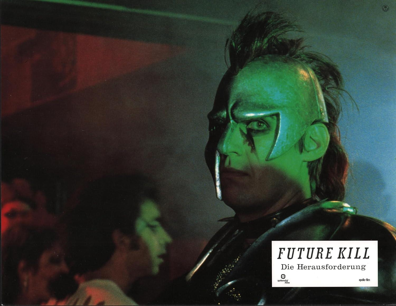 Ein Mann mit grüner Haut und einer Metallmaske, mit schwarzen Haaren. Der Titel "FUTURE KILL" steht unten rechts.