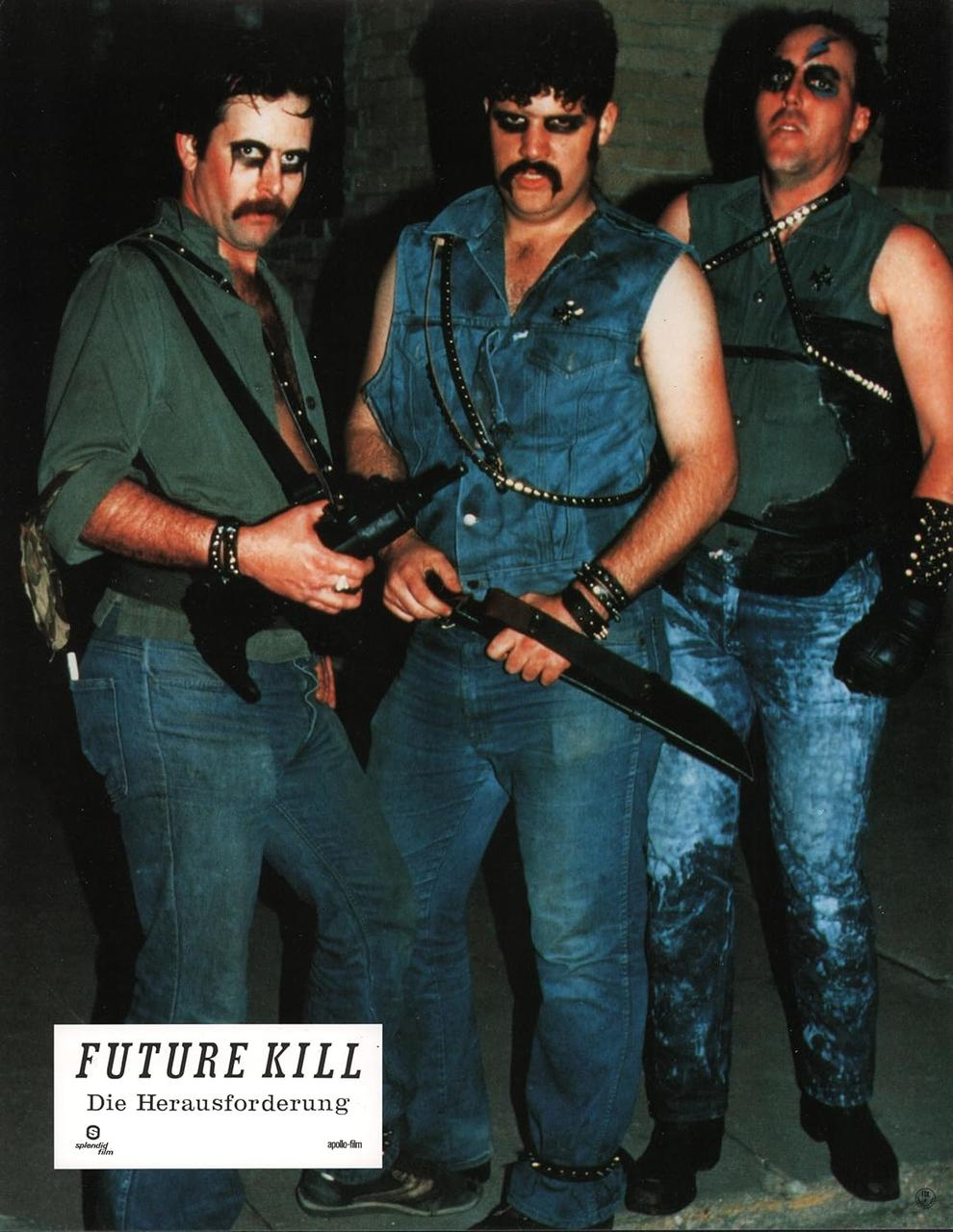 Drei Männer in Jeans, einer hält eine Klinge. Sie haben dunkles Make-up, Schnurrbärte und Lederaccessoires. Das Bild ist ein Filmplakat.