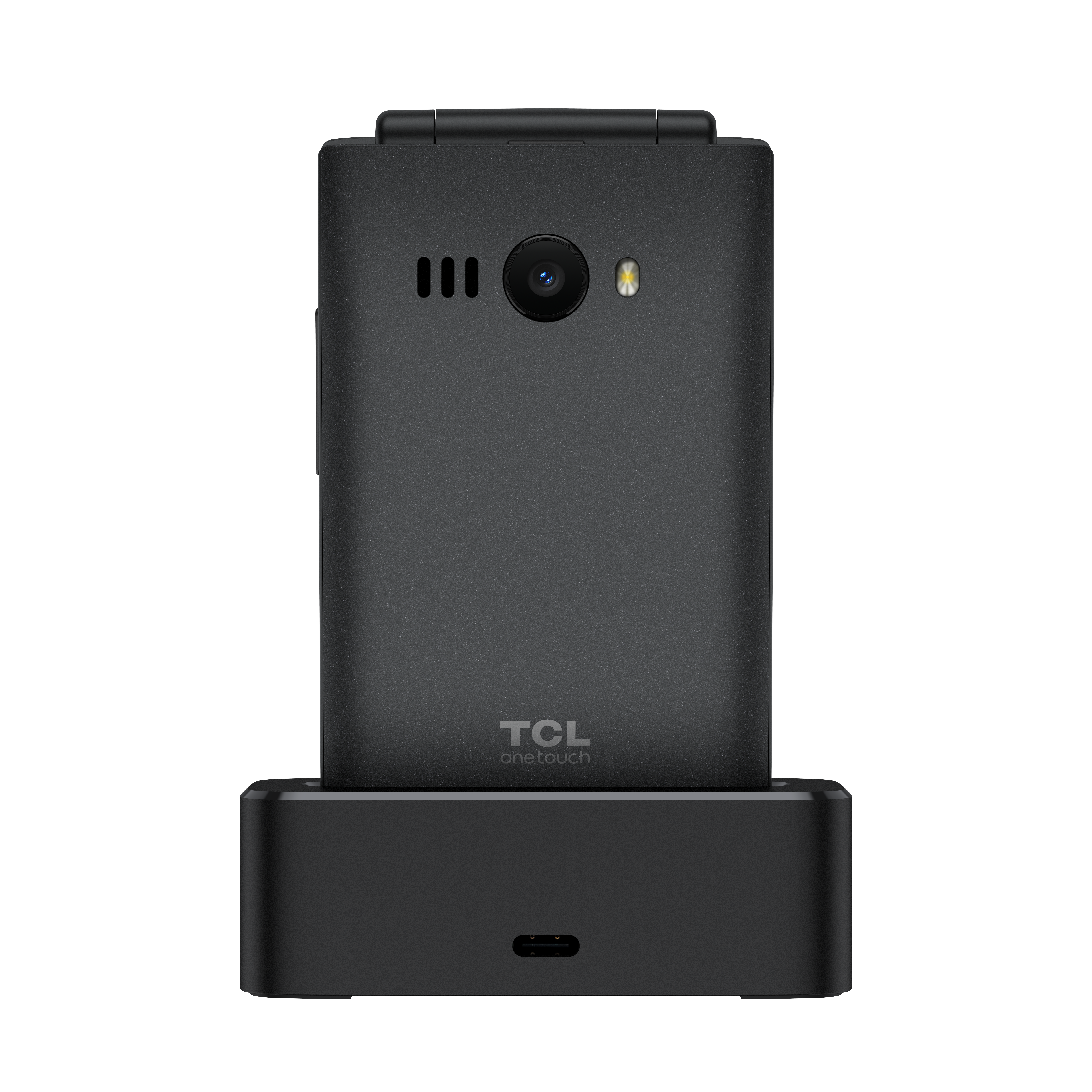 Fekete kagylótelefon fekete töltőállomáson. A telefonon kamera és TCL logó van. Fehér háttér.