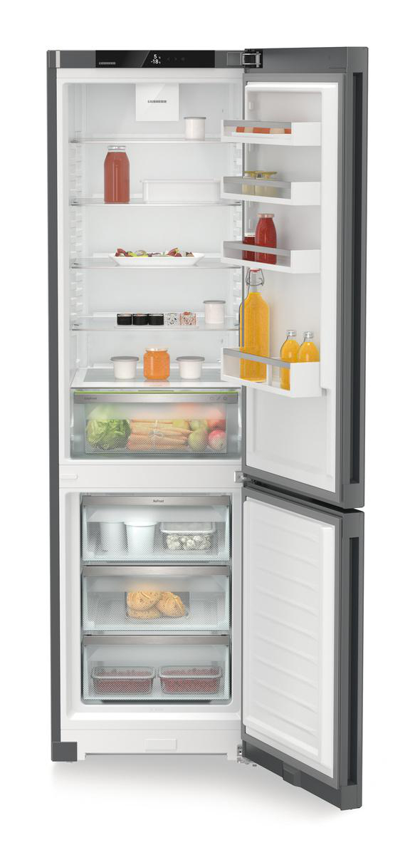 Ein offener Kühlschrank zeigt Obst, Gemüse, Gläser und Flaschen. Der Gefrierbereich ist ebenfalls geöffnet und zeigt gefrorene Lebensmittelbehälter.