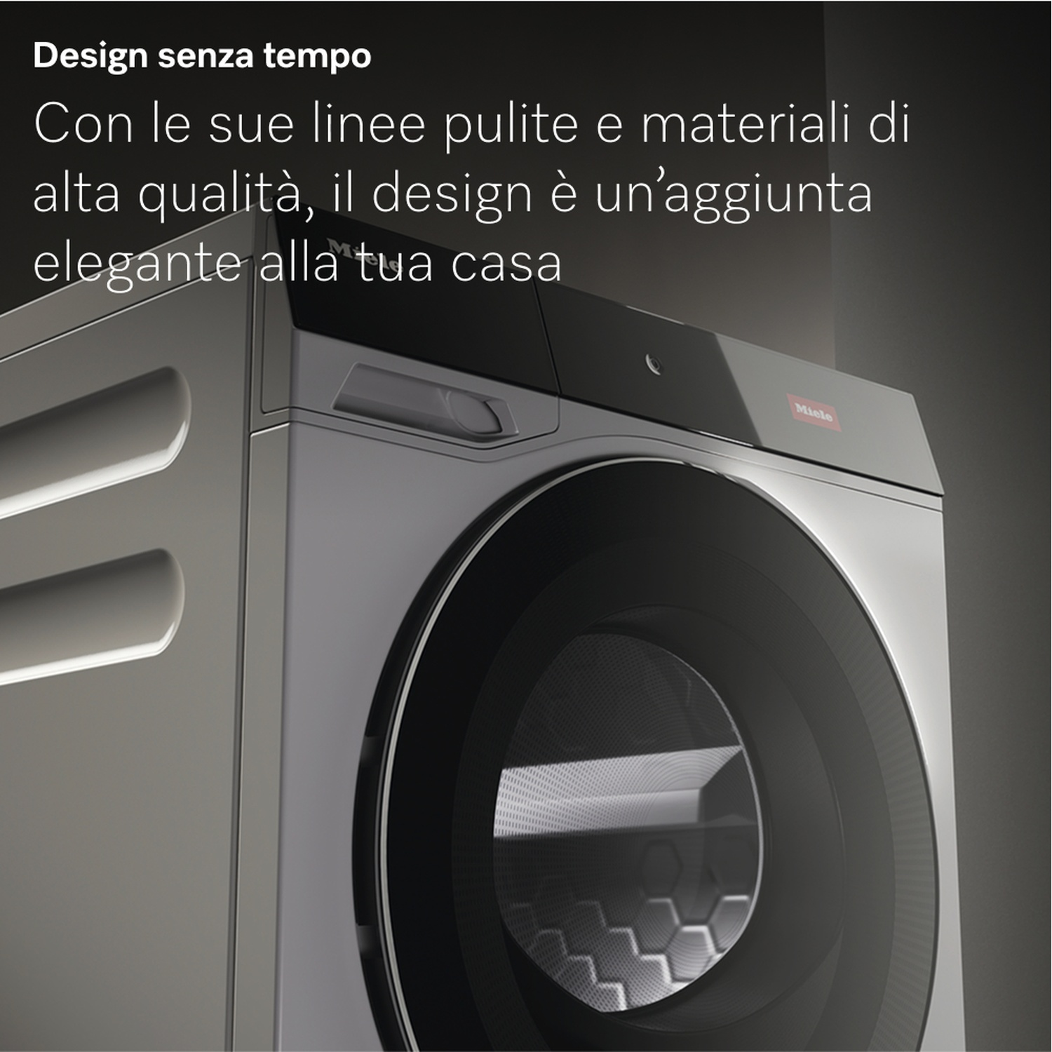 Lavatrice moderna in un ambiente grigio. Ha una grande porta in vetro scuro e il logo Miele è visibile.