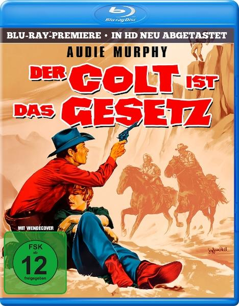 Ein Mann in Rot zieht eine Waffe auf eine Frau. Zwei Reiter im Hintergrund.