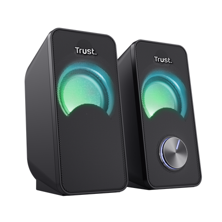 Dwa czarne głośniki z zielono-niebieskimi światłami. Prawy głośnik ma srebrną regulację głośności. Widoczna jest nazwa marki 'Trust'.