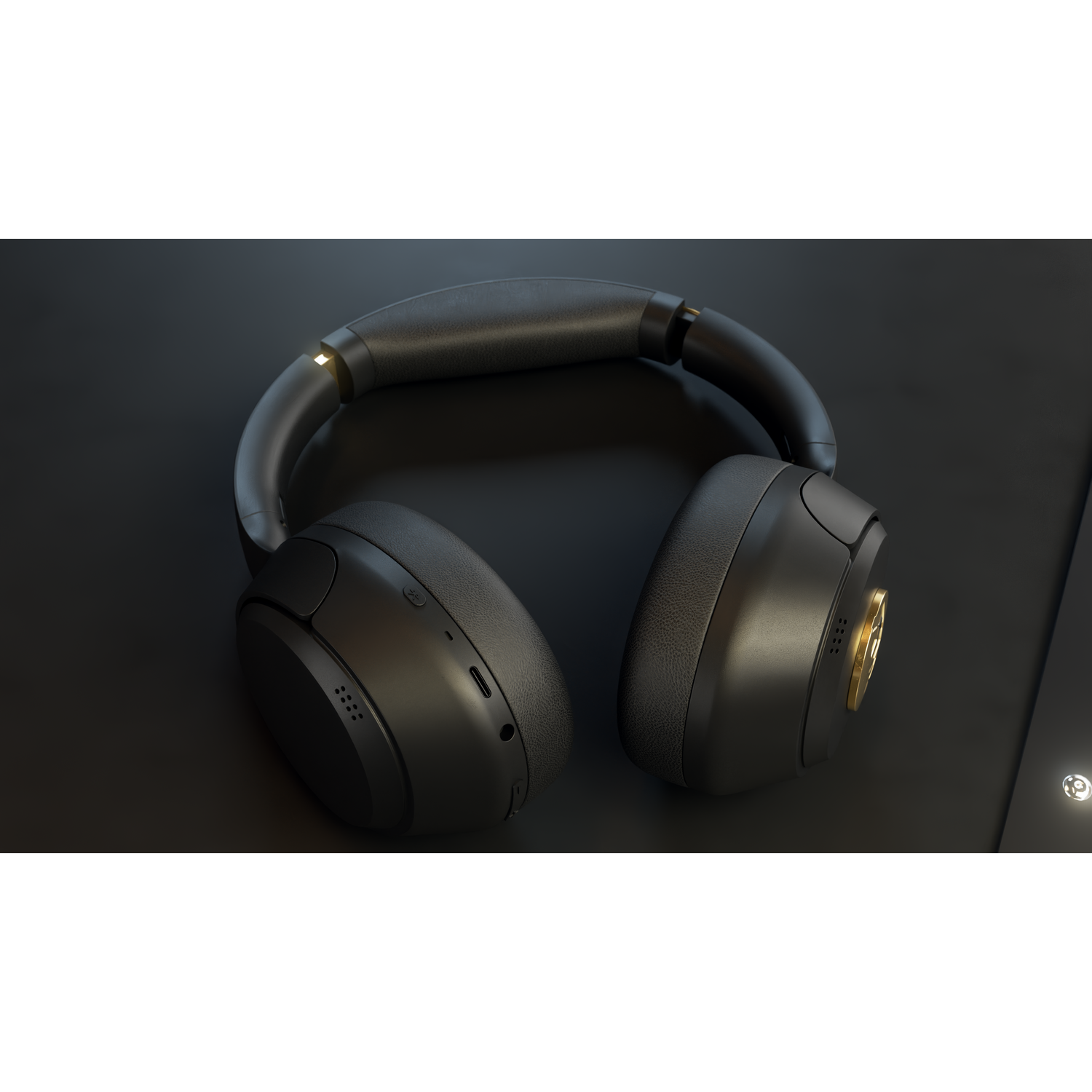 Black headphones on a dark surface. The headphones are detailed, with gold accents. The background is a dark, solid color.