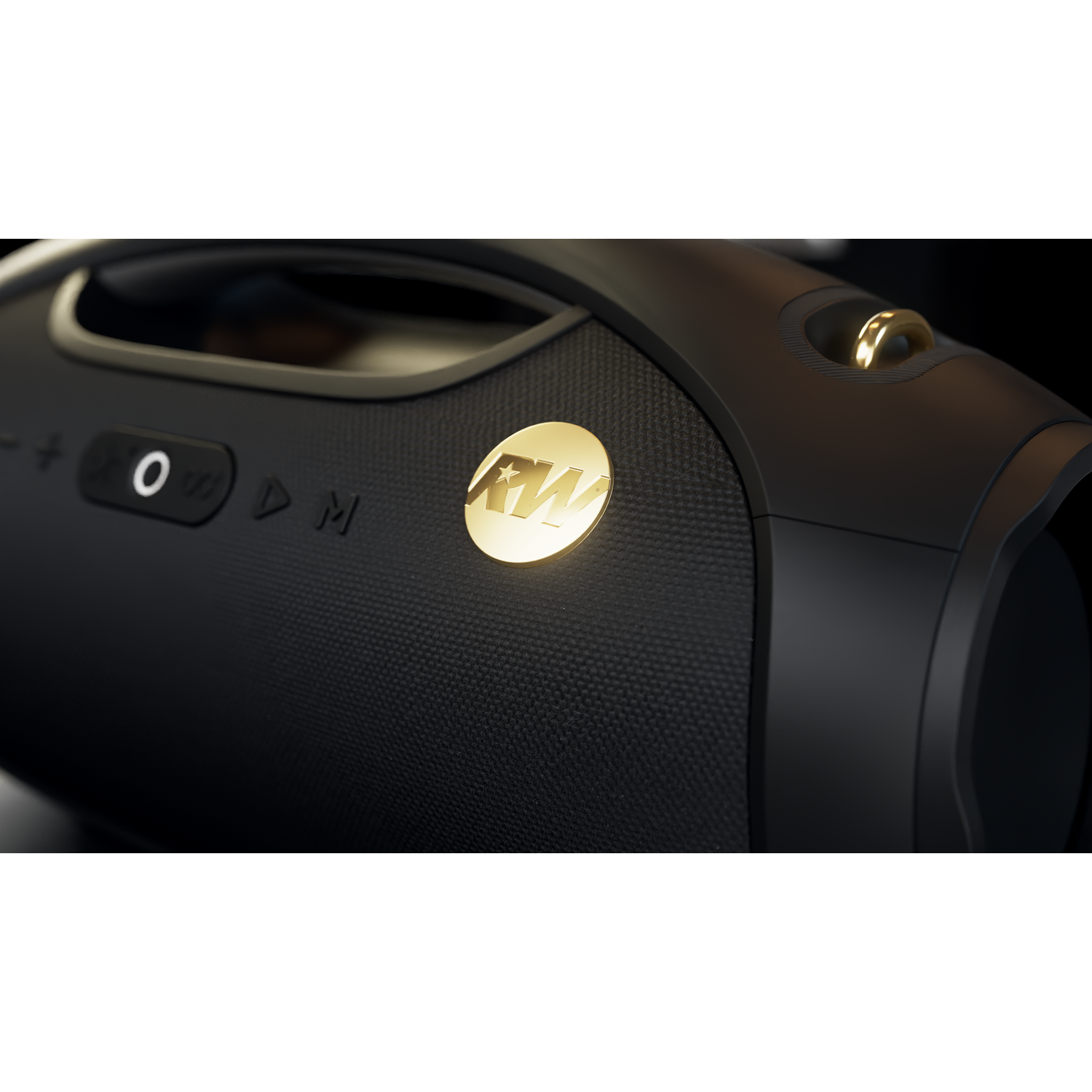 Black boombox with gold accents. Features a gold logo and control buttons. Handle visible. Dark background.