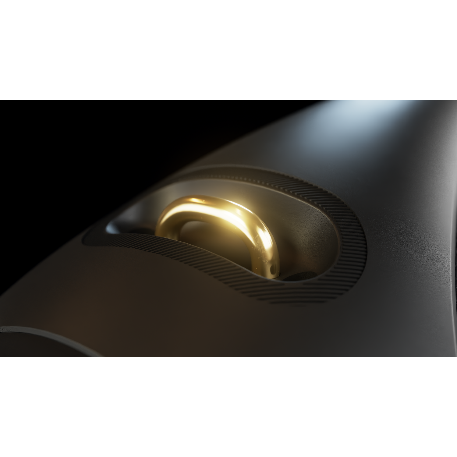 Close-up of a black device with a gold-colored, arched handle. The handle is set in a circular recess. The background is black.