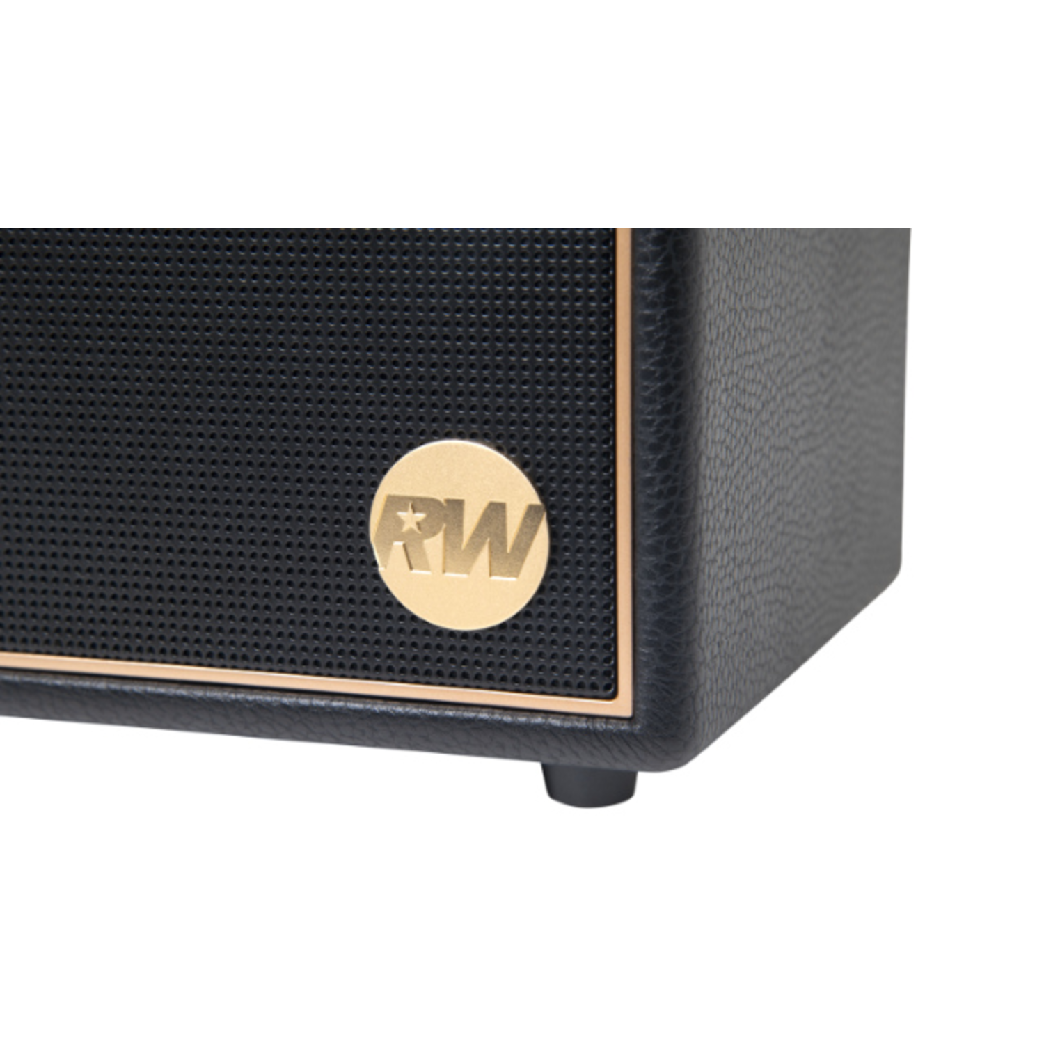 Close-up of a black speaker. It has a gold-colored trim and a golden logo with the letters 'RW'. The speaker is on a white surface.
