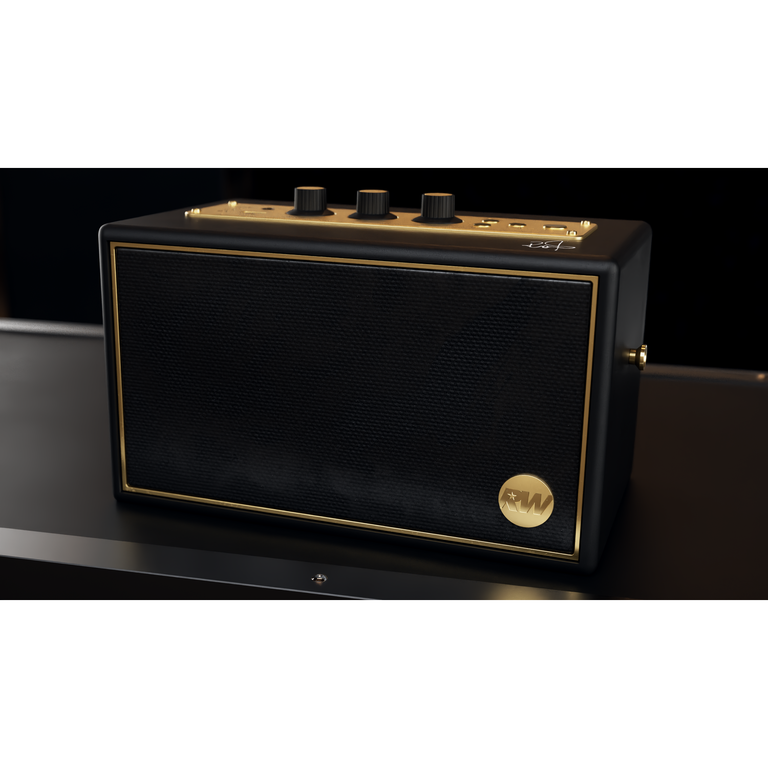 A black and gold speaker on a black surface. It has a mesh front, gold trim, knobs on top, and a gold logo.