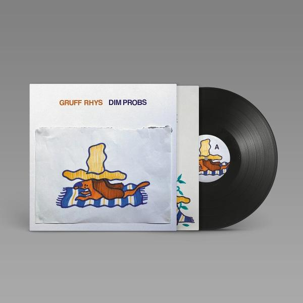 Albumcover: ein Cartoon-Hund auf einer Decke, mit dem Text 'Gruff Rhys Dim Probs'. Schwarze Vinyl-Schallplatte lugt heraus.