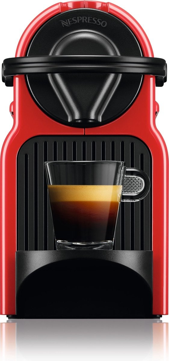 A red Nespresso machine with a cup of coffee. The coffee has a layered appearance. The machine has black accents.