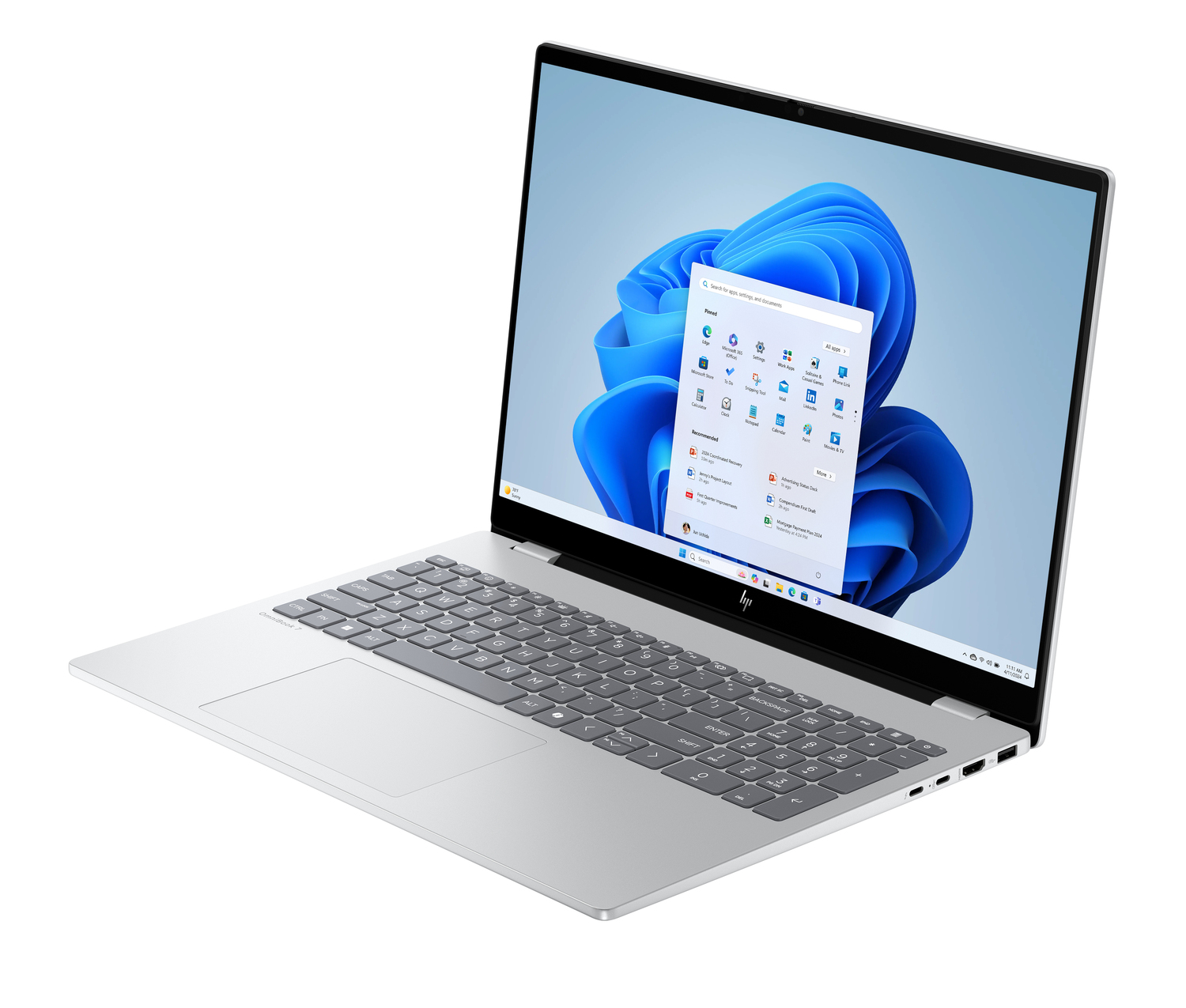 Laptop HP plateado abierto, mostrando interfaz Windows 11. Teclado visible. Pantalla muestra fondo azul abstracto e iconos de aplicaciones.