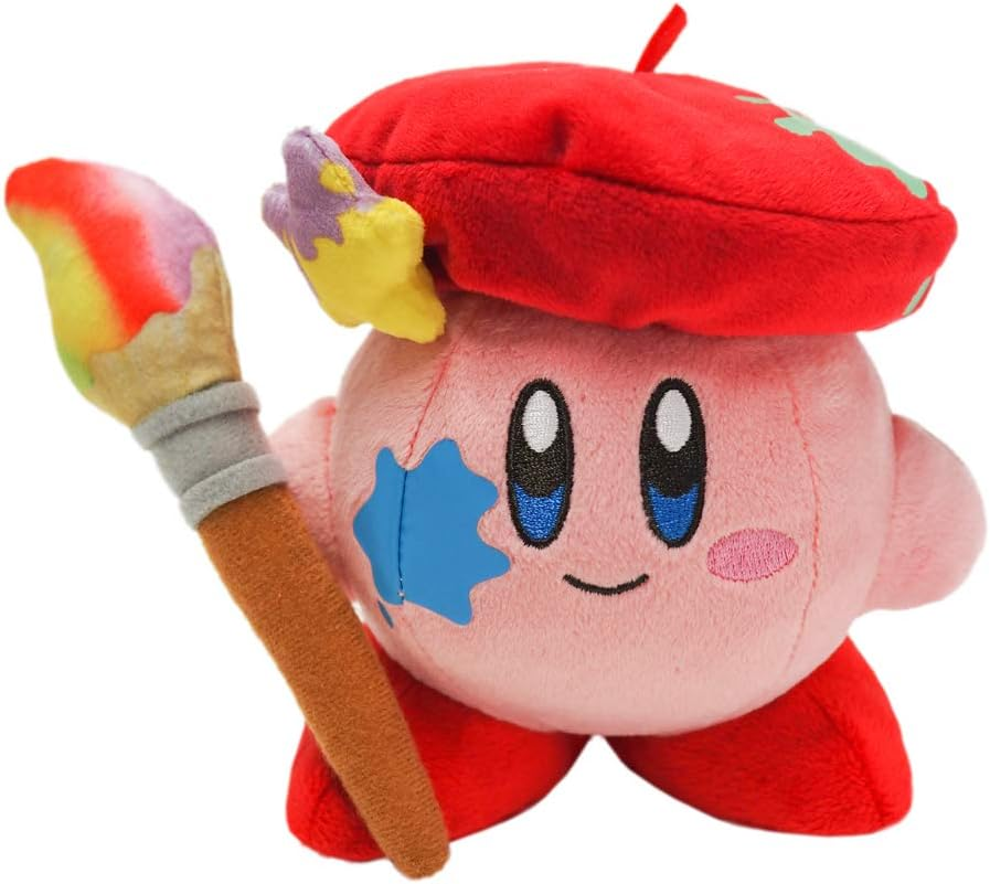 Rosa Kirby-Plüschtier mit Pinsel und roter Baskenmütze mit Farbspritzern. Der Pinsel hat bunte Farbe.