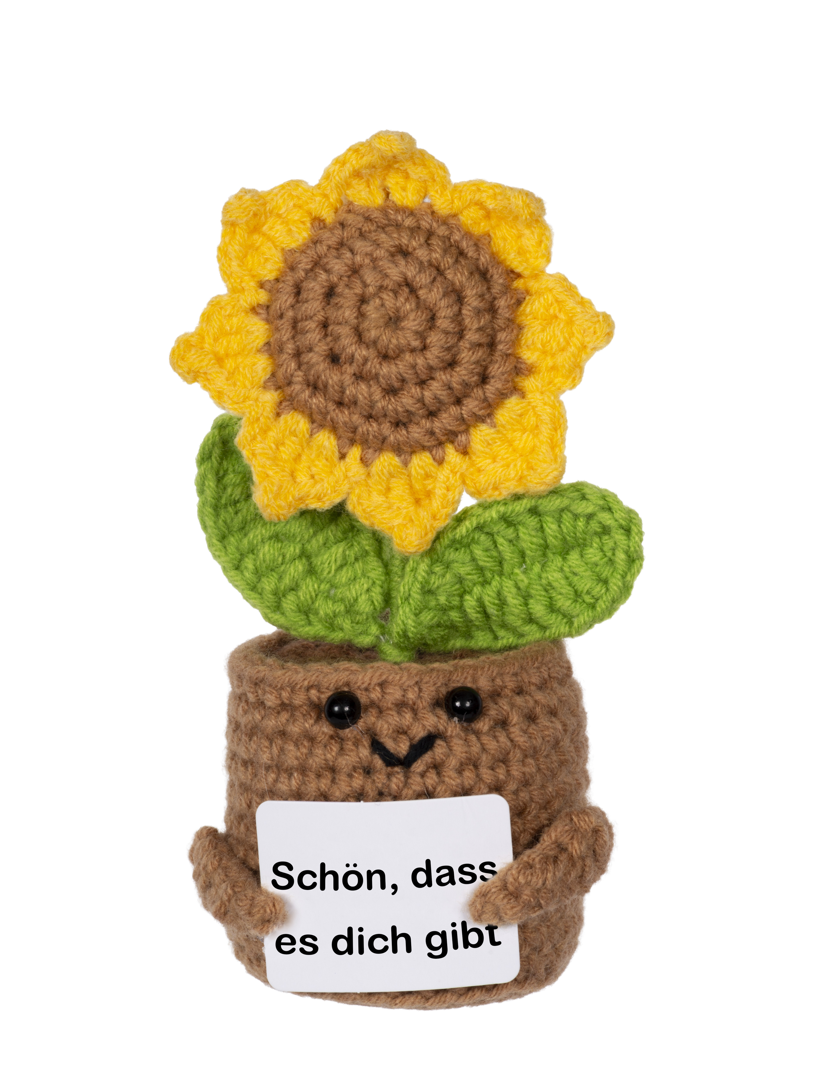 Gehäkelte Sonnenblume in einem Topf, lächelnd, mit einem Schild mit der Aufschrift 'Schön, dass es dich gibt'.