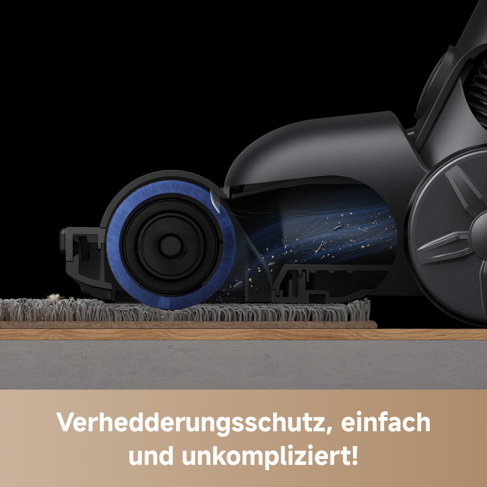 Ein Staubsaugerkopf mit blauer Rolle reinigt einen Teppich. Staubpartikel sind sichtbar. Schwarzer Hintergrund.