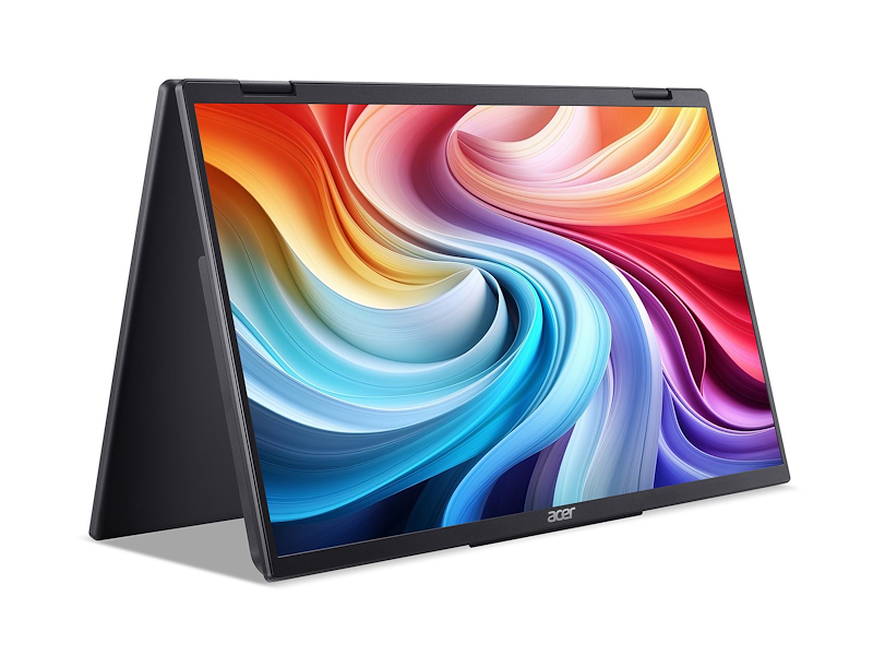 Un portátil Acer negro está abierto. La pantalla muestra arte abstracto colorido. El portátil está sobre una superficie blanca.
