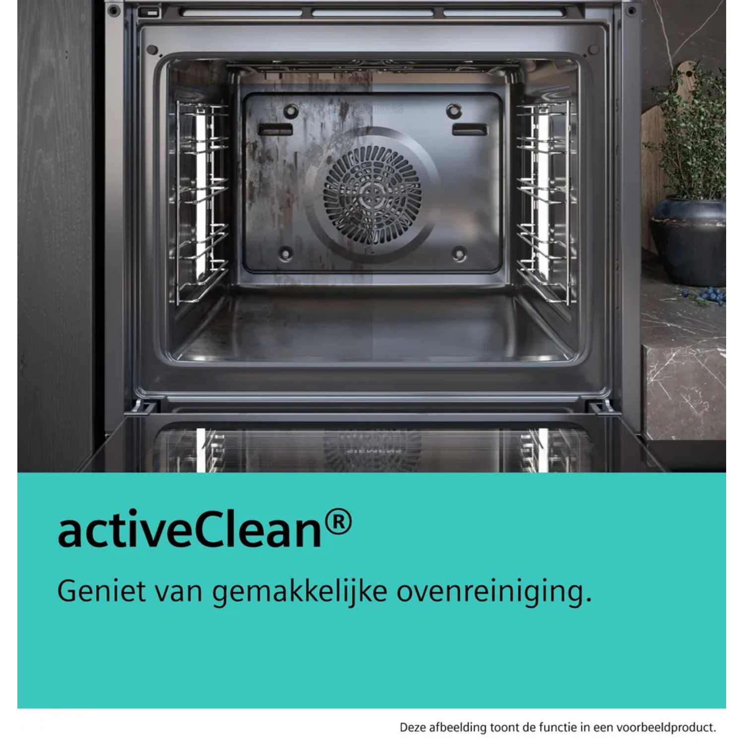 An open oven interior. The oven is dirty, with a fan in the back. Below is a green box with activeClean text.