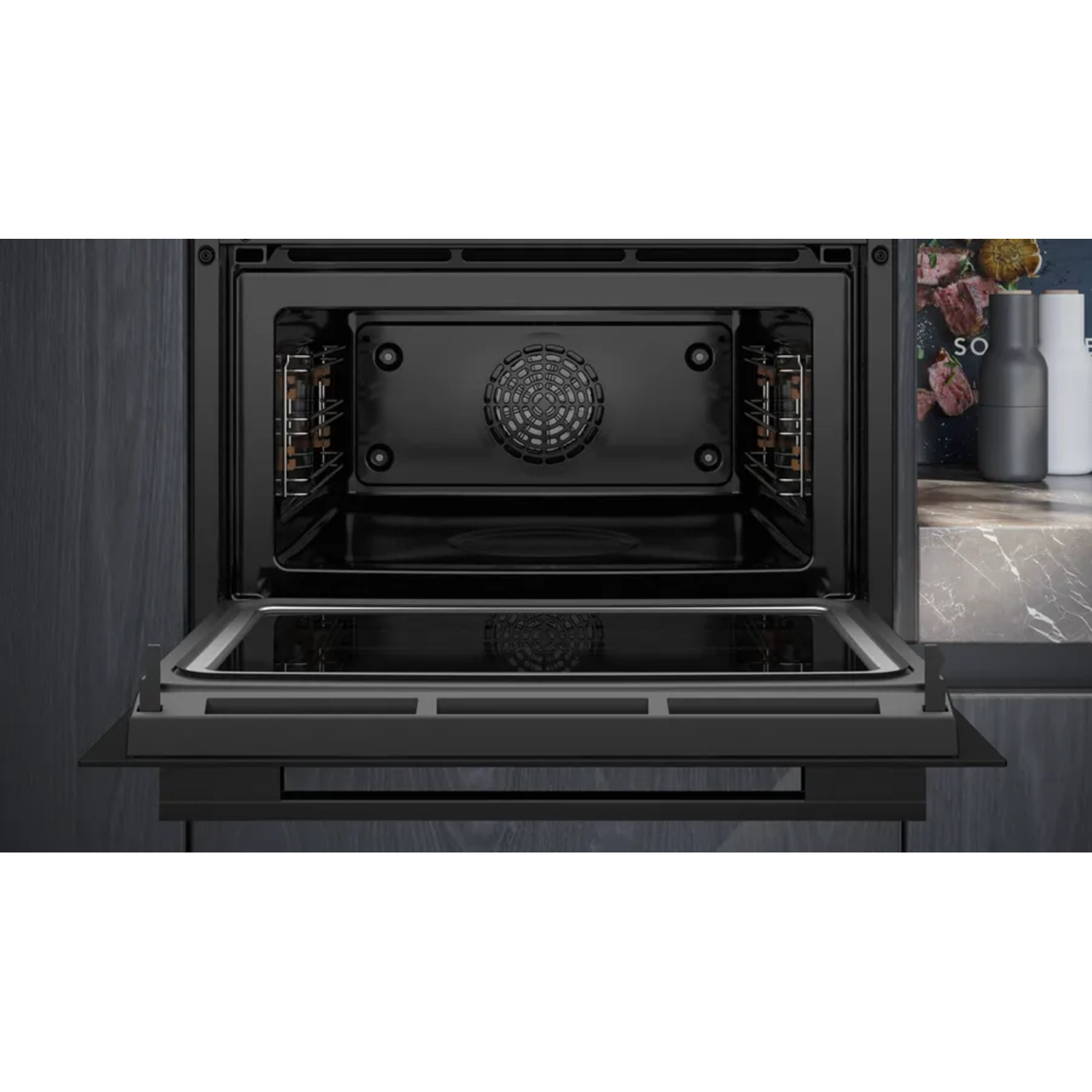 An open black oven with a glass door, shelves, and a fan. It is built into a dark gray cabinet with a marble countertop.