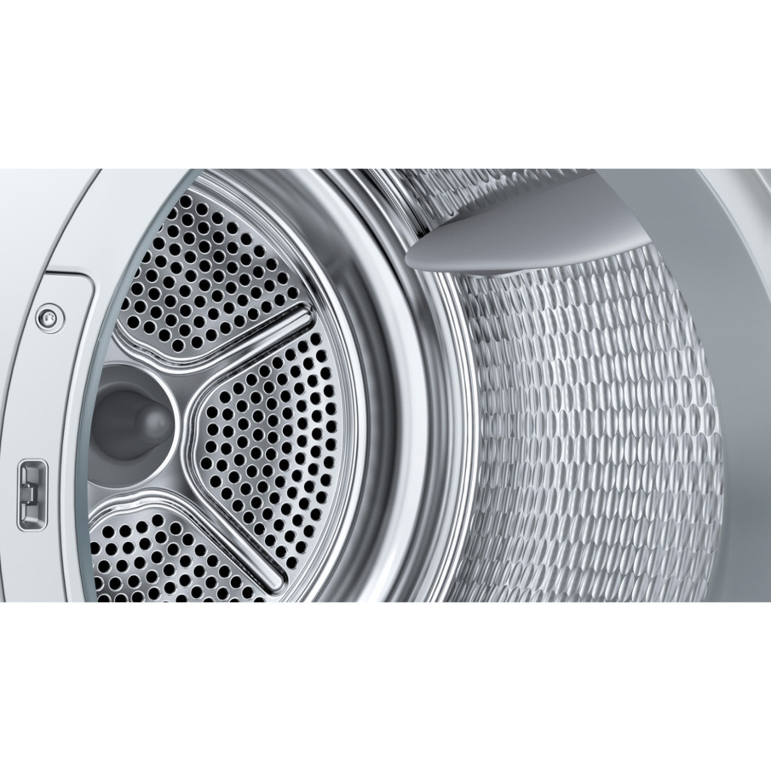 Close-up of a washing machine drum. The inside is metallic, with a perforated front and a textured back. The door is open.